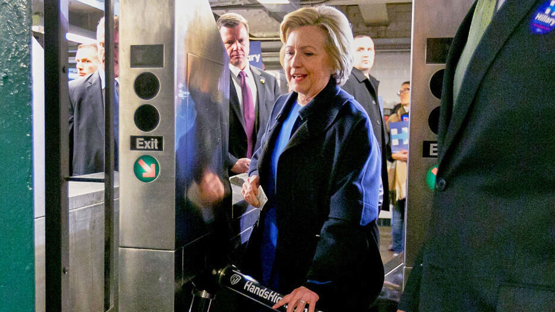 Former Democrat presidential candidate Hillary Clinton holds her MetroCard as she goes through the turnstile to enter the subway in the Bronx borough of New York, April 7, 2016.