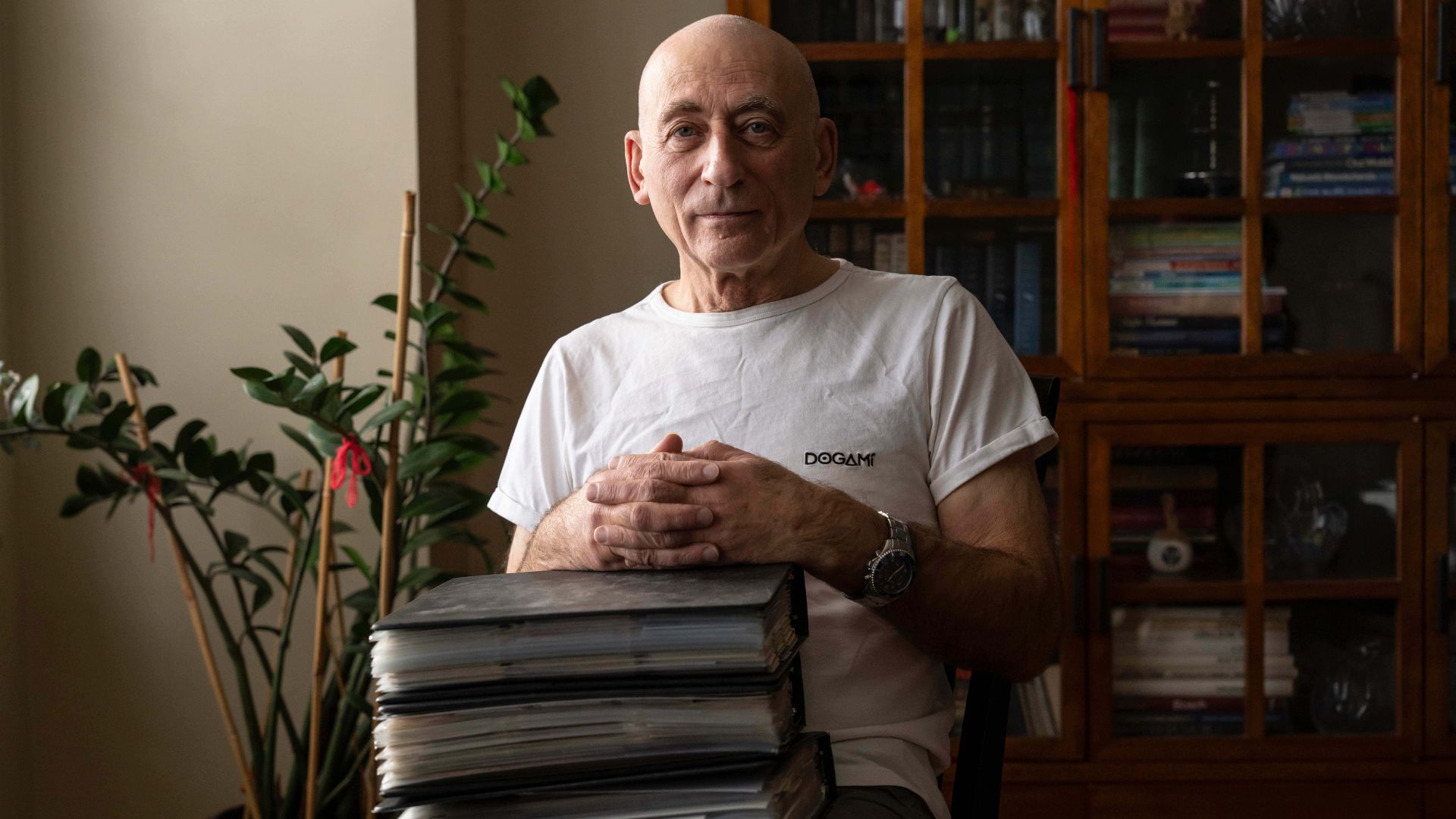 Lev Radin poses for a picture with his MetroCard collection, Dec. 10, 2025, in New York.