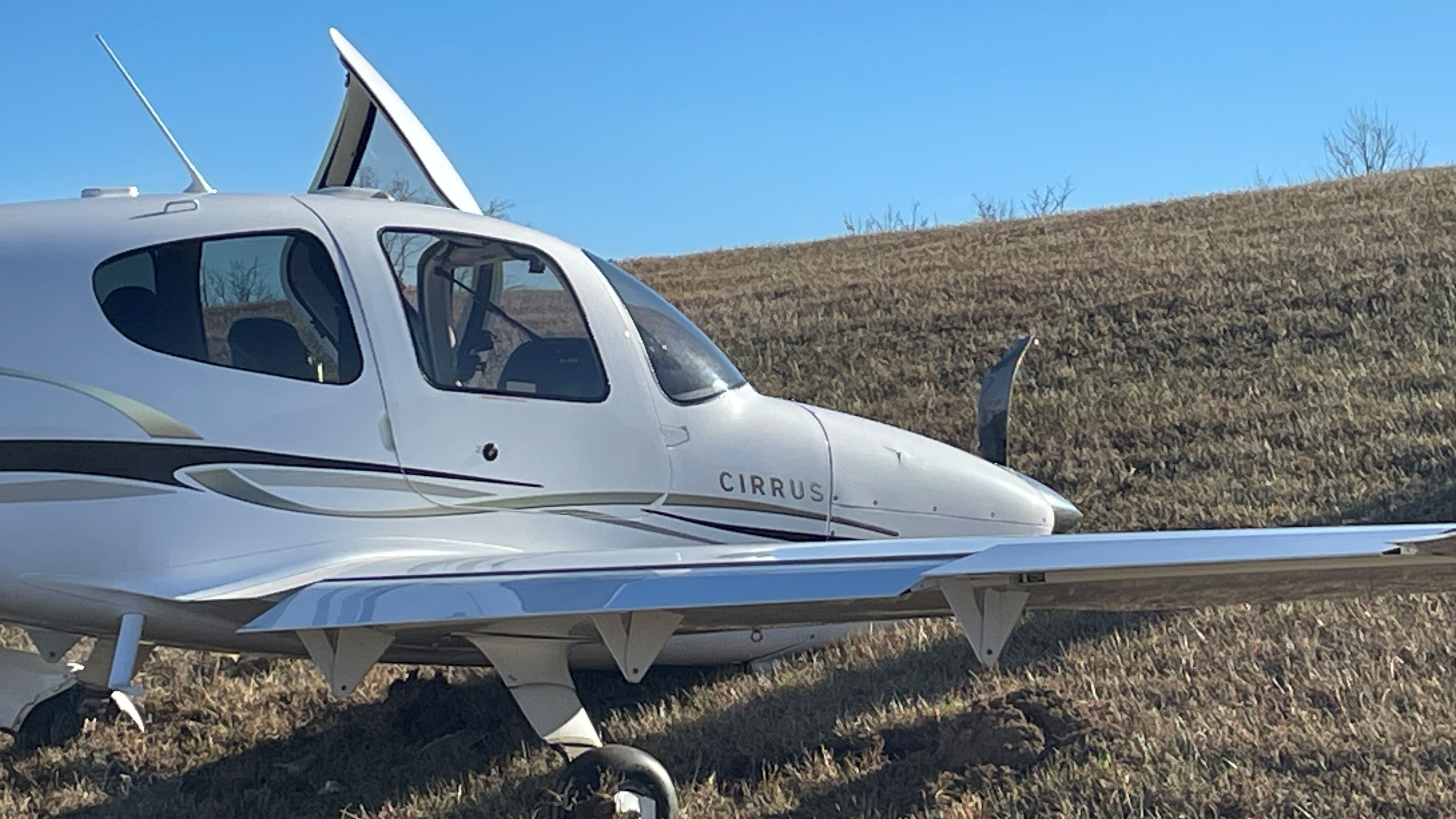 The pilot of a Cirrus SR-20 was conducting touch-and-go exercises when a wind gust blew the plane off the runway as he was attempting to land.