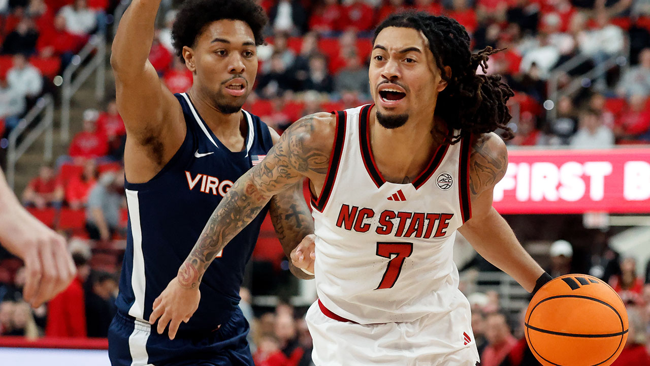 N.C. State's Alyn Breed drives on Virginia's Malik Thomas on Saturday in Raleigh.