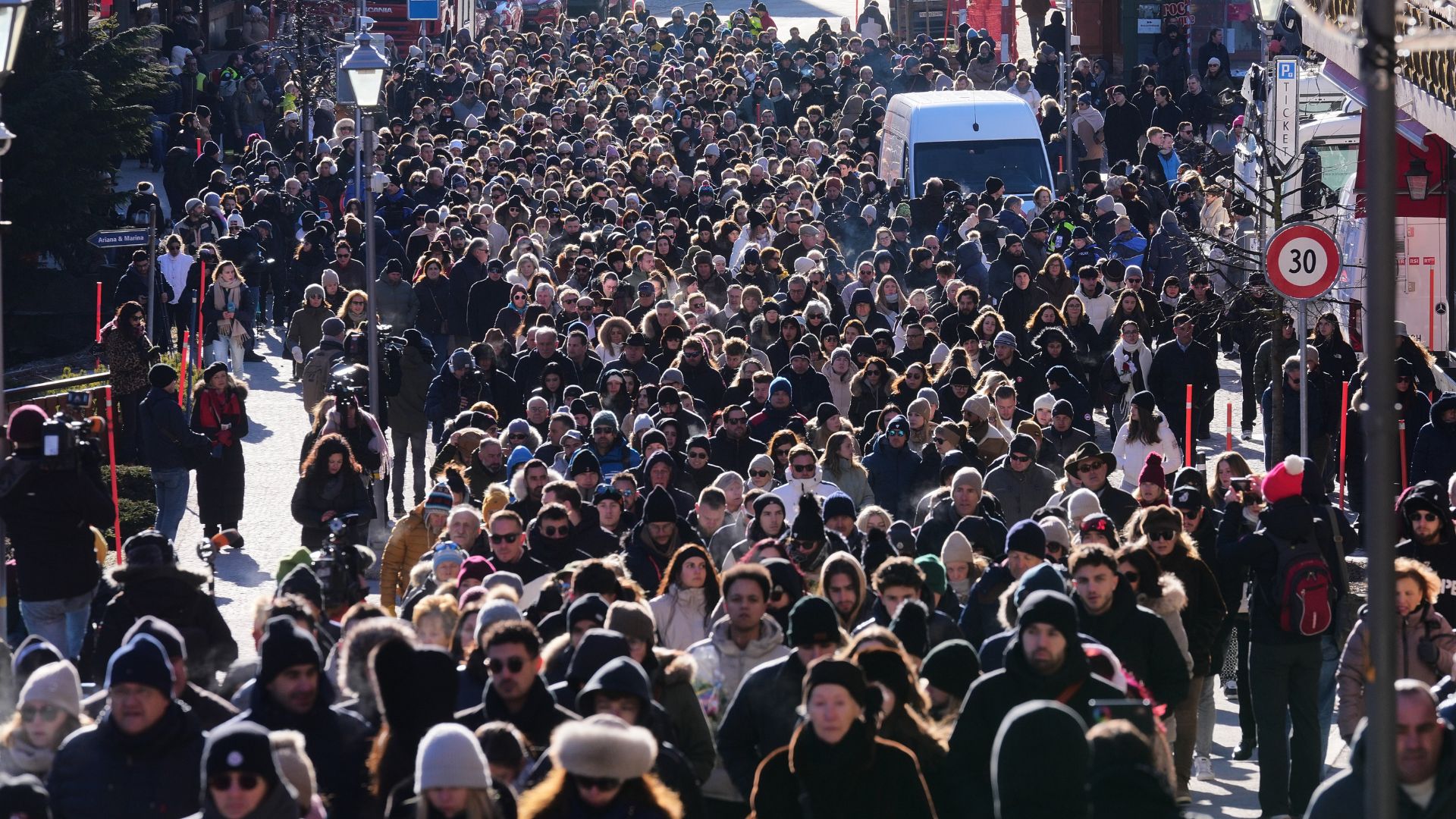 People walk during a memorial procession in Crans-Montana, Swiss Alps, Switzerland, Jan. 4, 2026, after a fire in Le Constellation bar during the New Year's celebrations.