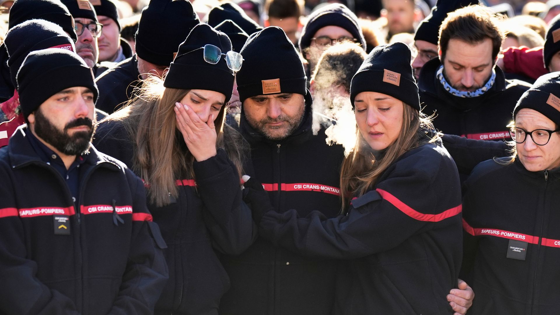 Firefighters cry as they attend a memorial march in Crans-Montana, Swiss Alps, Switzerland, Jan. 4, 2026, after a fire in Le Constellation bar during the New Year's celebrations.
