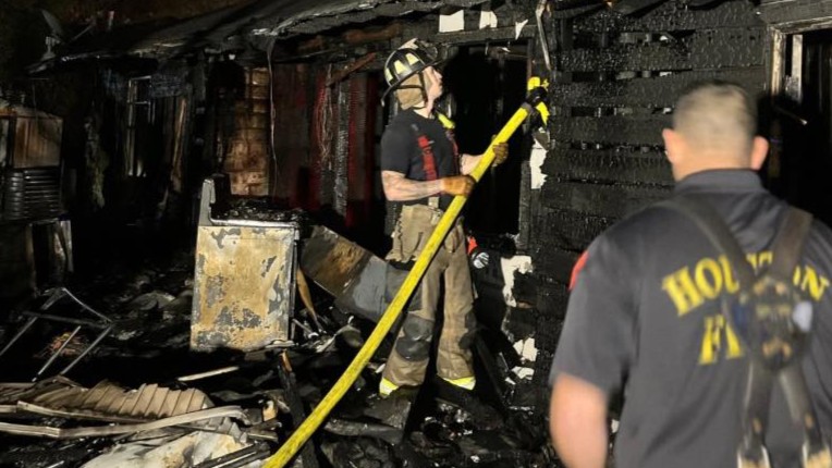 A Houston Fire Department firefighter working at a fire in the South Park area, where investigators said they found a man, possibly a squatter, deceased inside a home for sale.