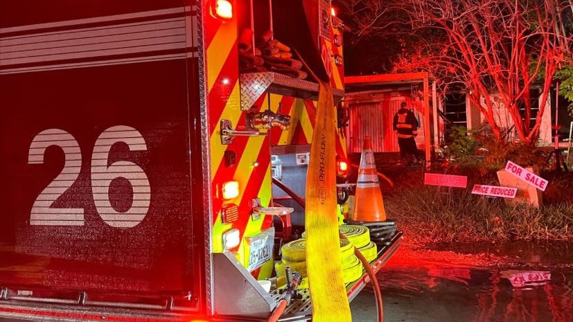 Images showed a sign reading "For Sale" at a home where investigators say a possible squatter was found dead after a fire.