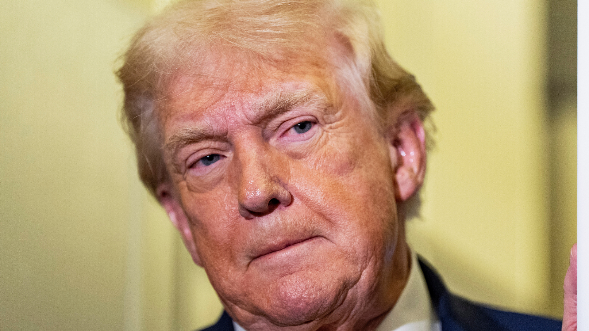 President Donald Trump listens as he was speaking with reporters while in flight on Air Force One, Sunday, Jan. 4, 2026, as returning to Joint Base Andrews, Md.