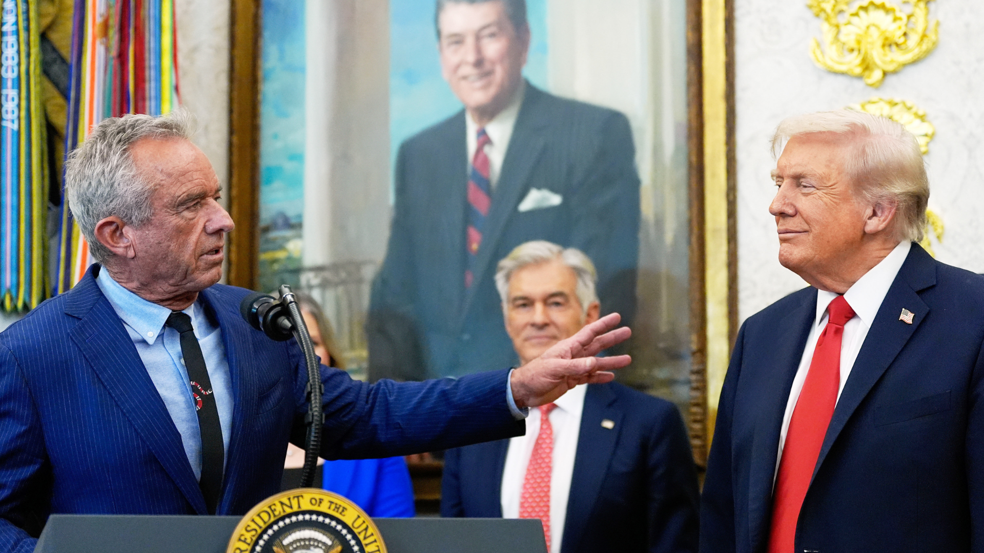 FILE - President Donald Trump listens as Health and Human Services Secretary Robert F. Kennedy Jr., speaks in the Oval Office of the White House, Oct. 16, 2025, in Washington.