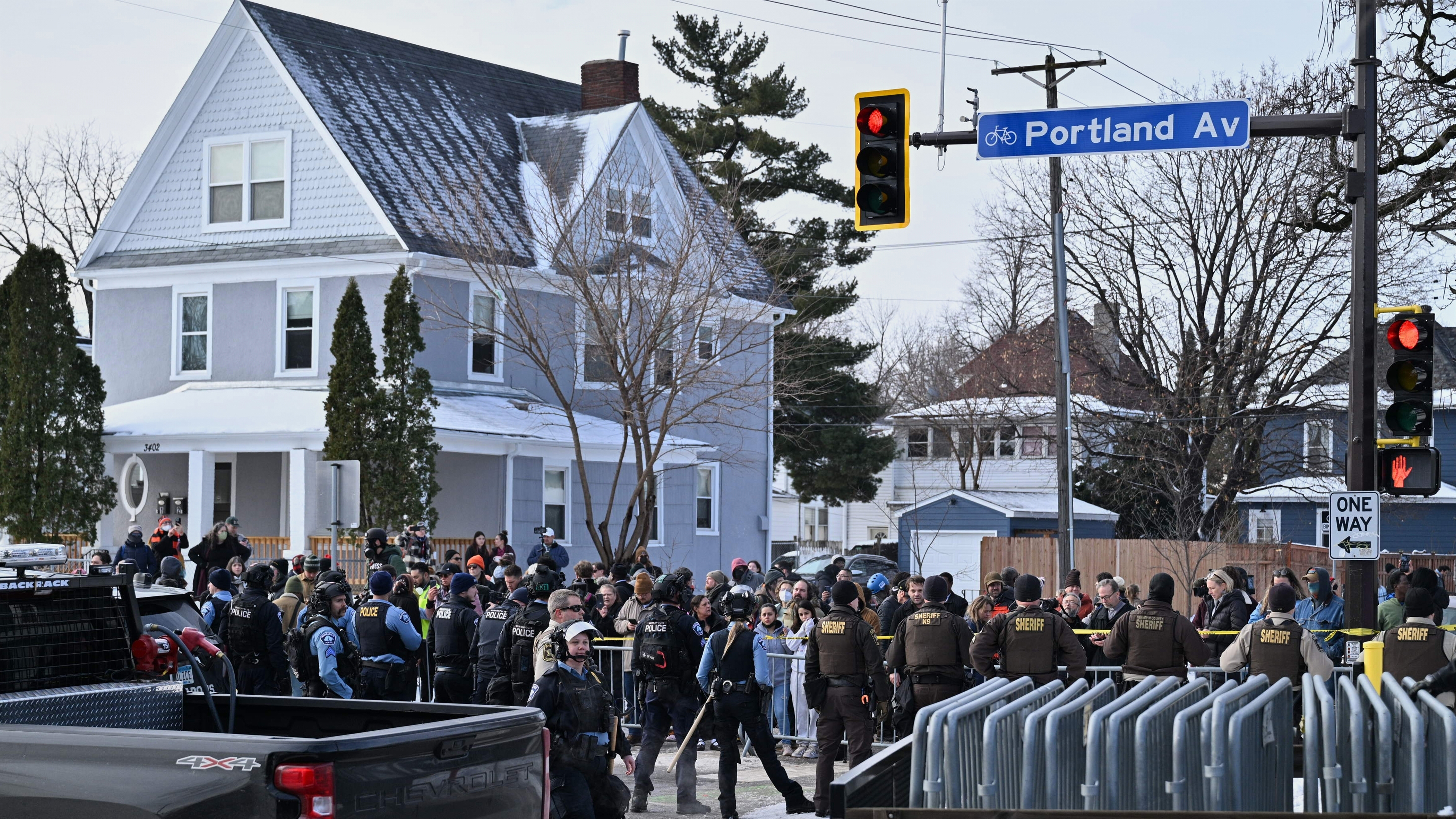 People protest as law enforcement officers attend to the scene of the shooting involving federal law enforcement agents, Wednesday, Jan. 7, 2026, in Minneapolis.