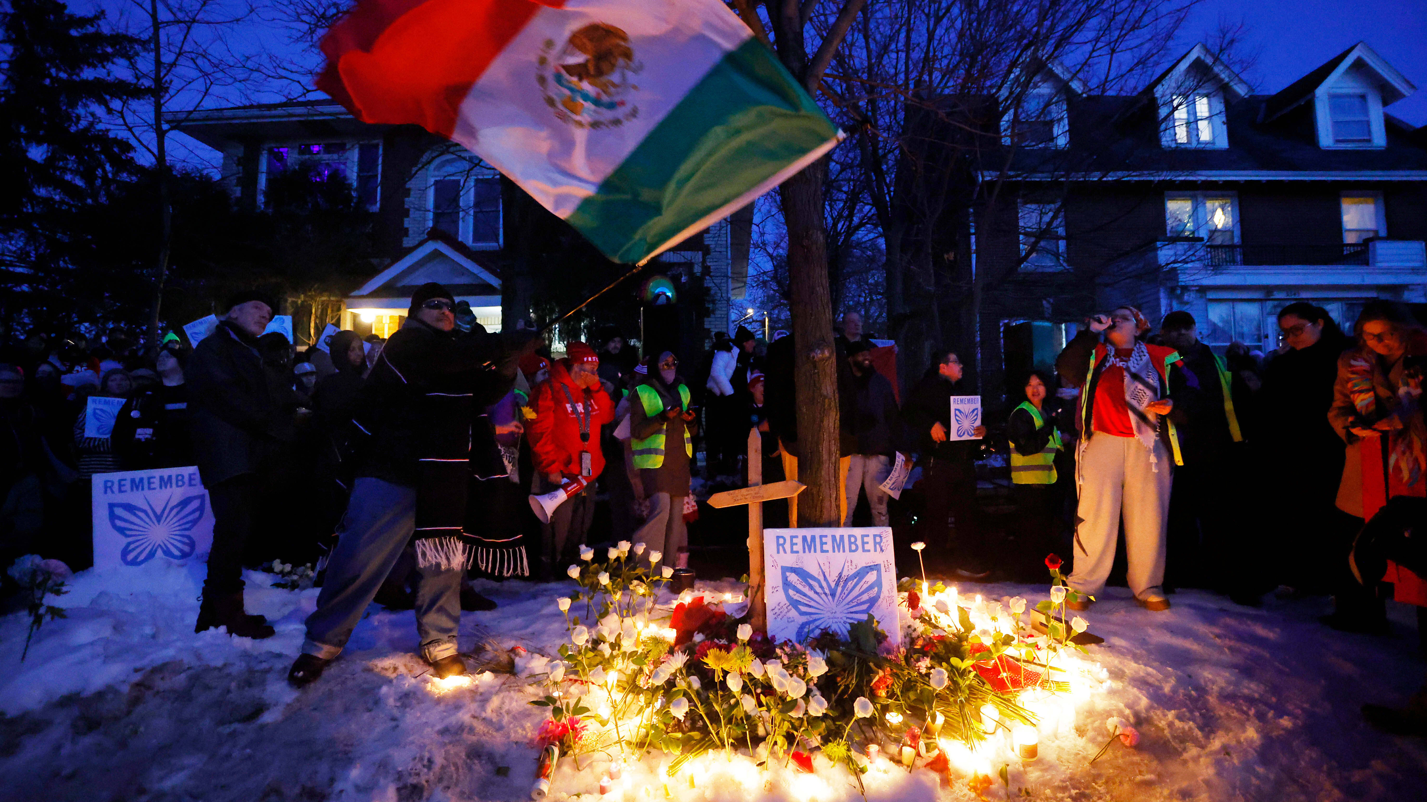 People gather for a vigil after an Immigration and Customs Enforcement officer shot and killed a woman earlier in the day, Wednesday, Jan. 7, 2026, in Minneapolis.