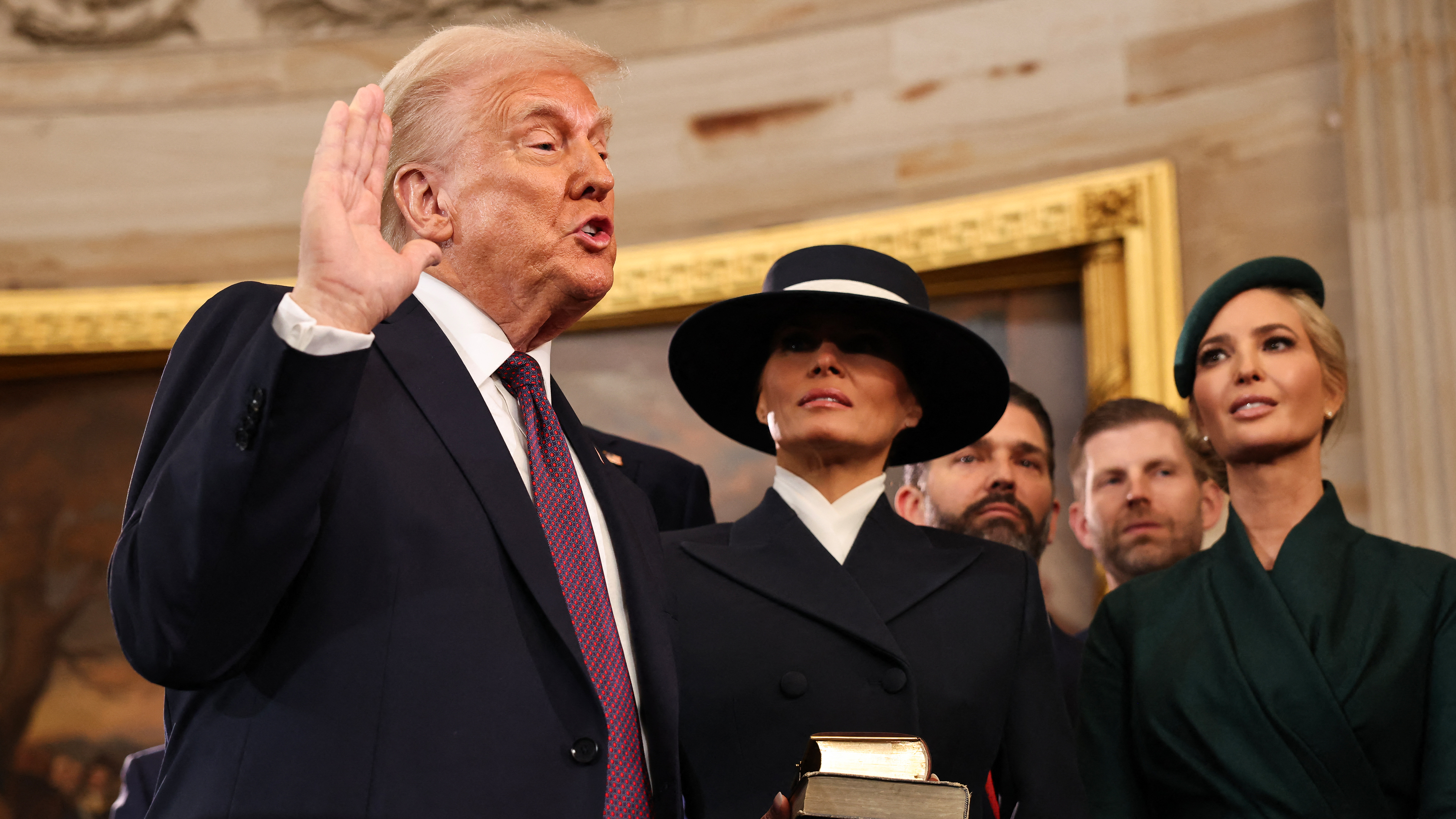 US President-elect Donald Trump takes the oath of office as Melania Trump, Ivanka Trump, Donald Trump Jr. and Eric Trump look on during inauguration ceremonies in the Rotunda of the U.S. Capitol on January 20, 2025 in Washington, DC.