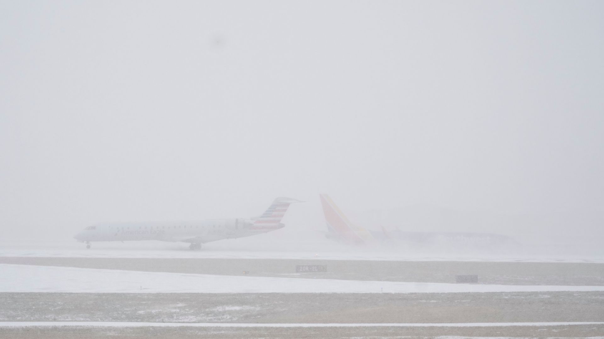 Planes move on the tarmac at the Nashville International Airport during a winter storm Saturday, Jan. 24, 2026, in Nashville, Tenn.