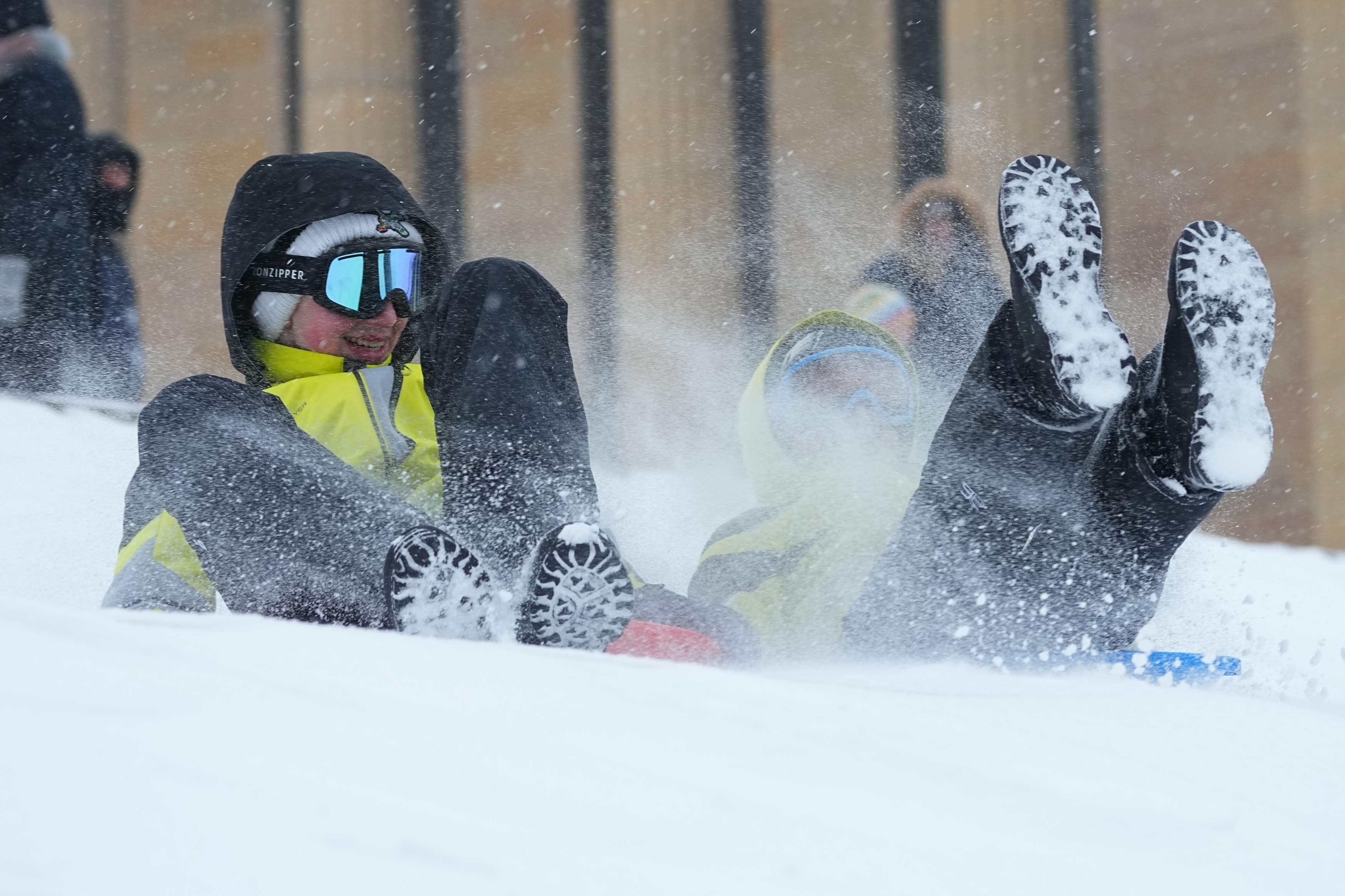 People sled at Philadelphia Art Museum steps by the Rocky statue during a winter storm on Sunday, Jan. 25, 2026.