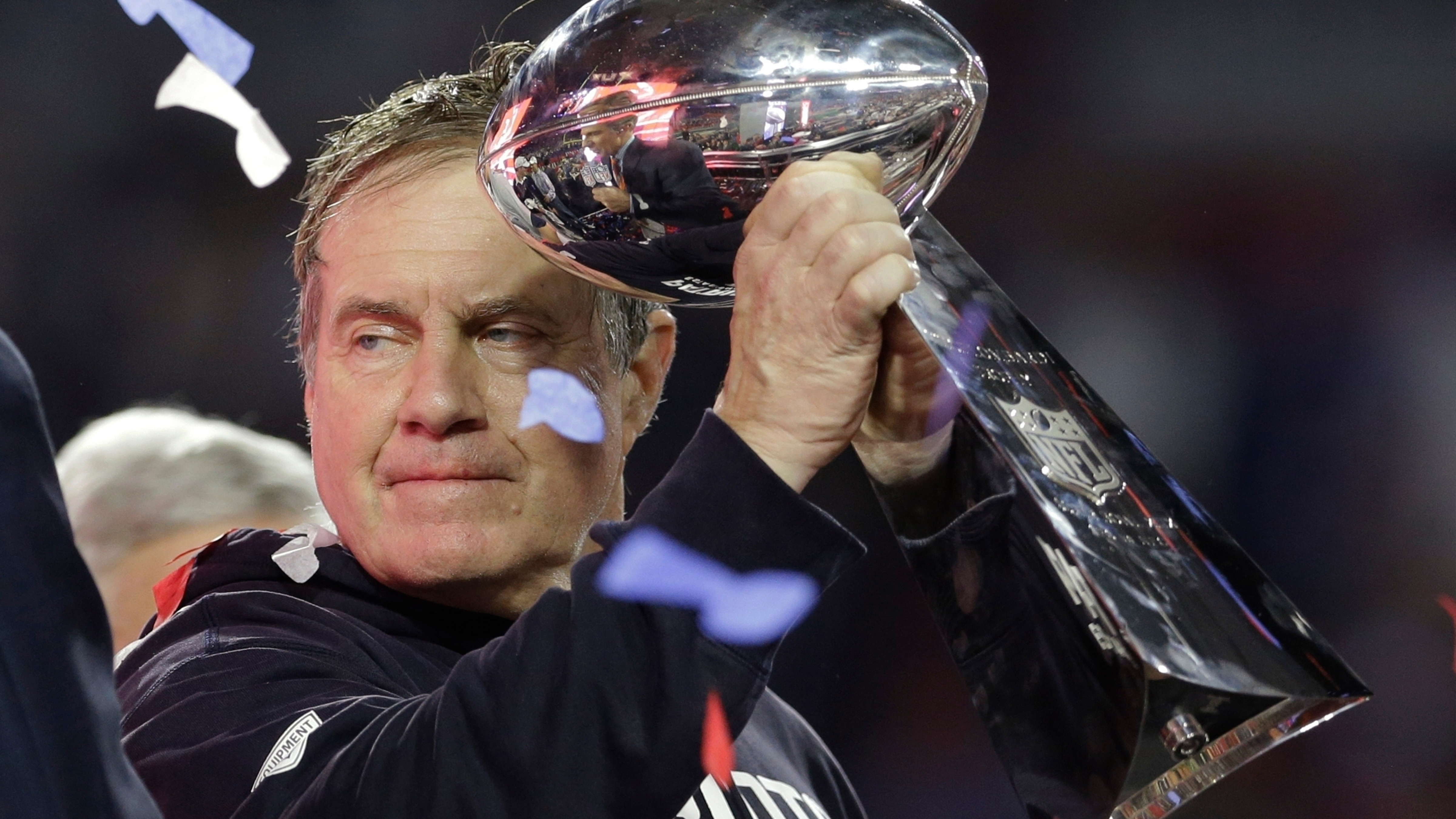 New England Patriots head coach Bill Belichick holds up the Vince Lombardi Trophy as he celebrates the Patriots' victory over the Seattle Seahawks in NFL Super Bowl XLIX football game Feb. 1, 2015, in Glendale, Ariz.