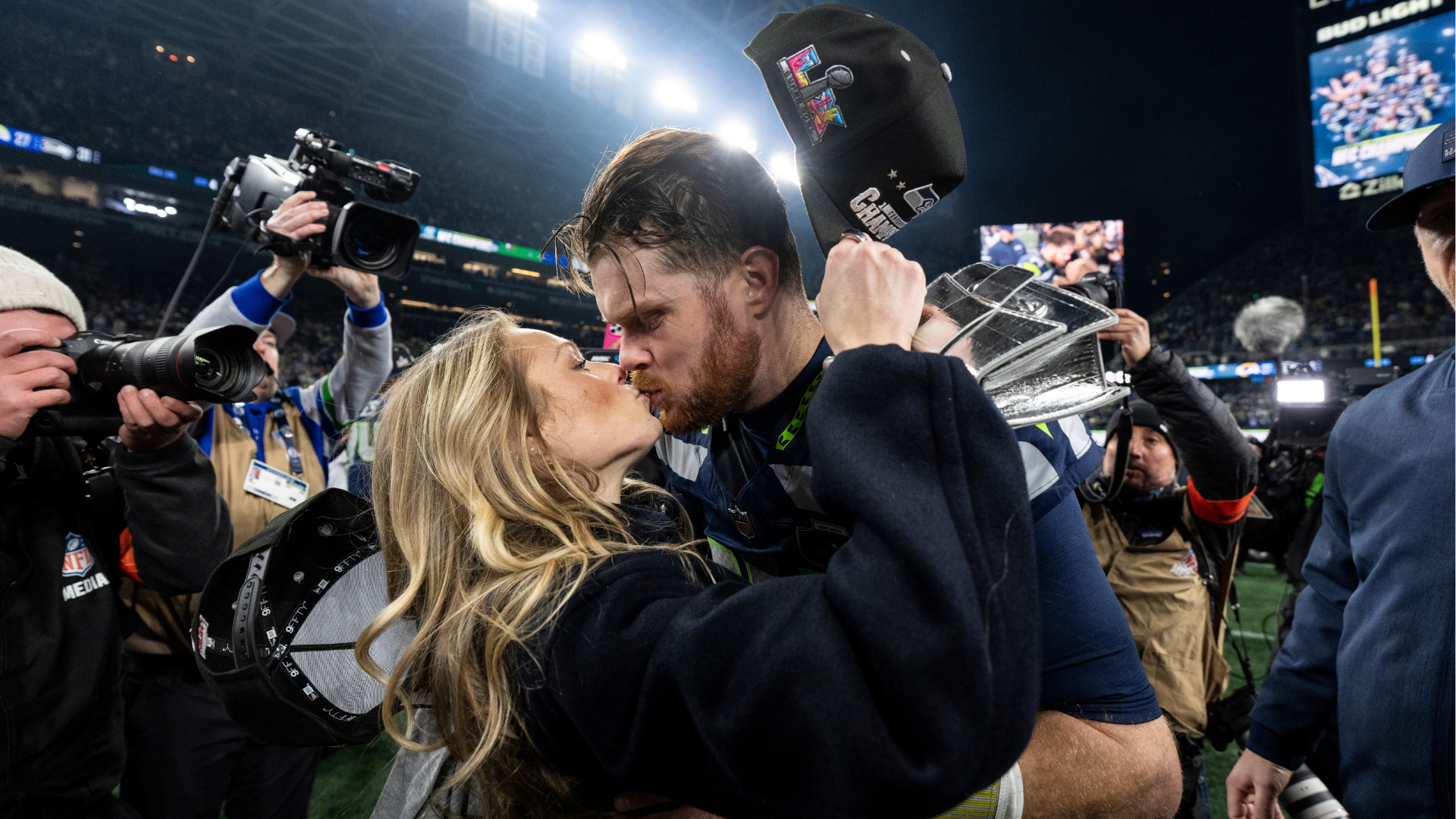 Sam Darnold #14 of the Seattle Seahawks shares a moment with his fiance Katie Hoofnagle following an NFC Championship NFL football game against the Los Angeles Rams at Lumen Field on January 25, 2026 in Seattle, Washington. 
