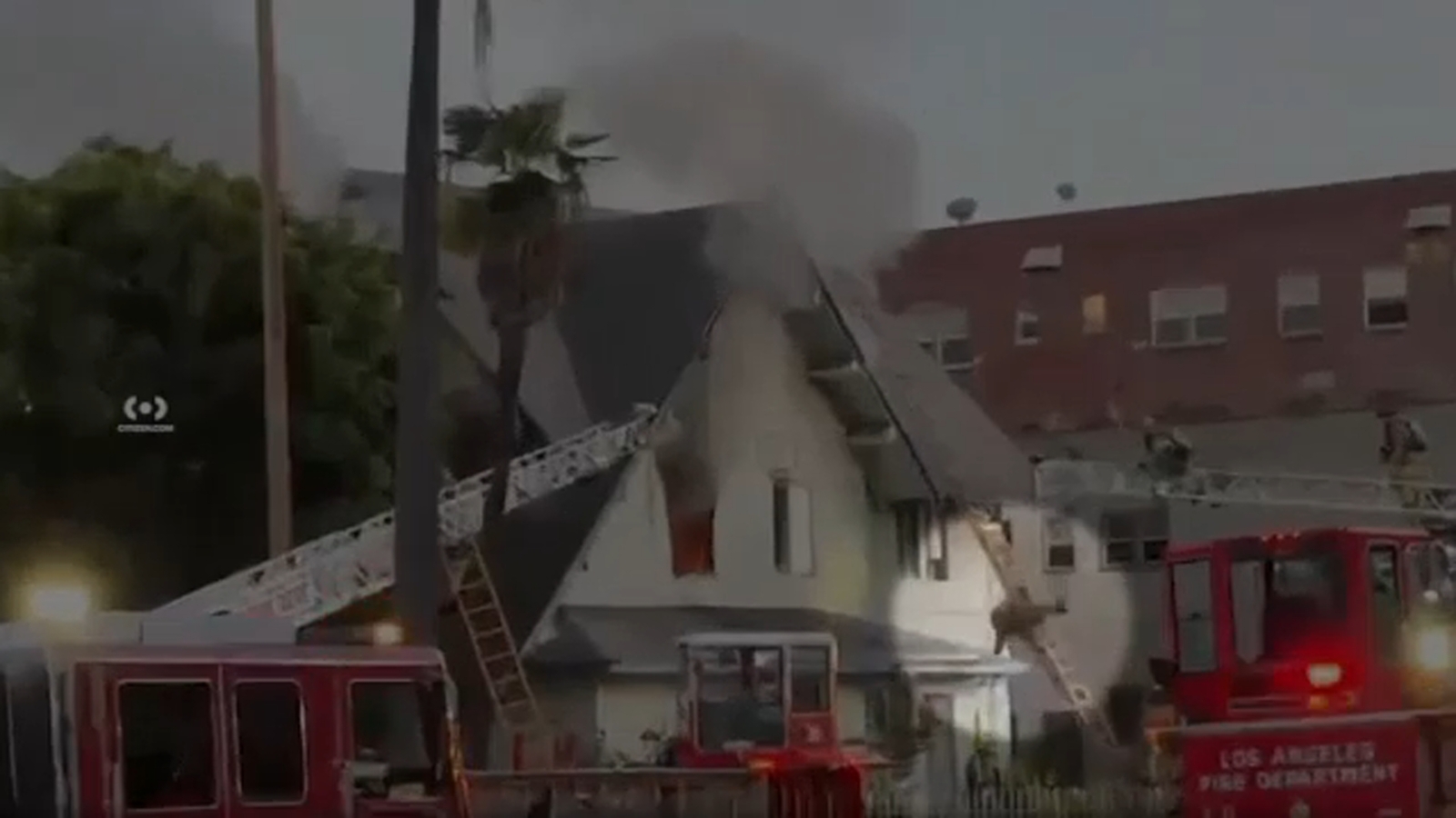 Shocking video shows LAFD firefighter fall from ladder while battling Arlington Heights house fire