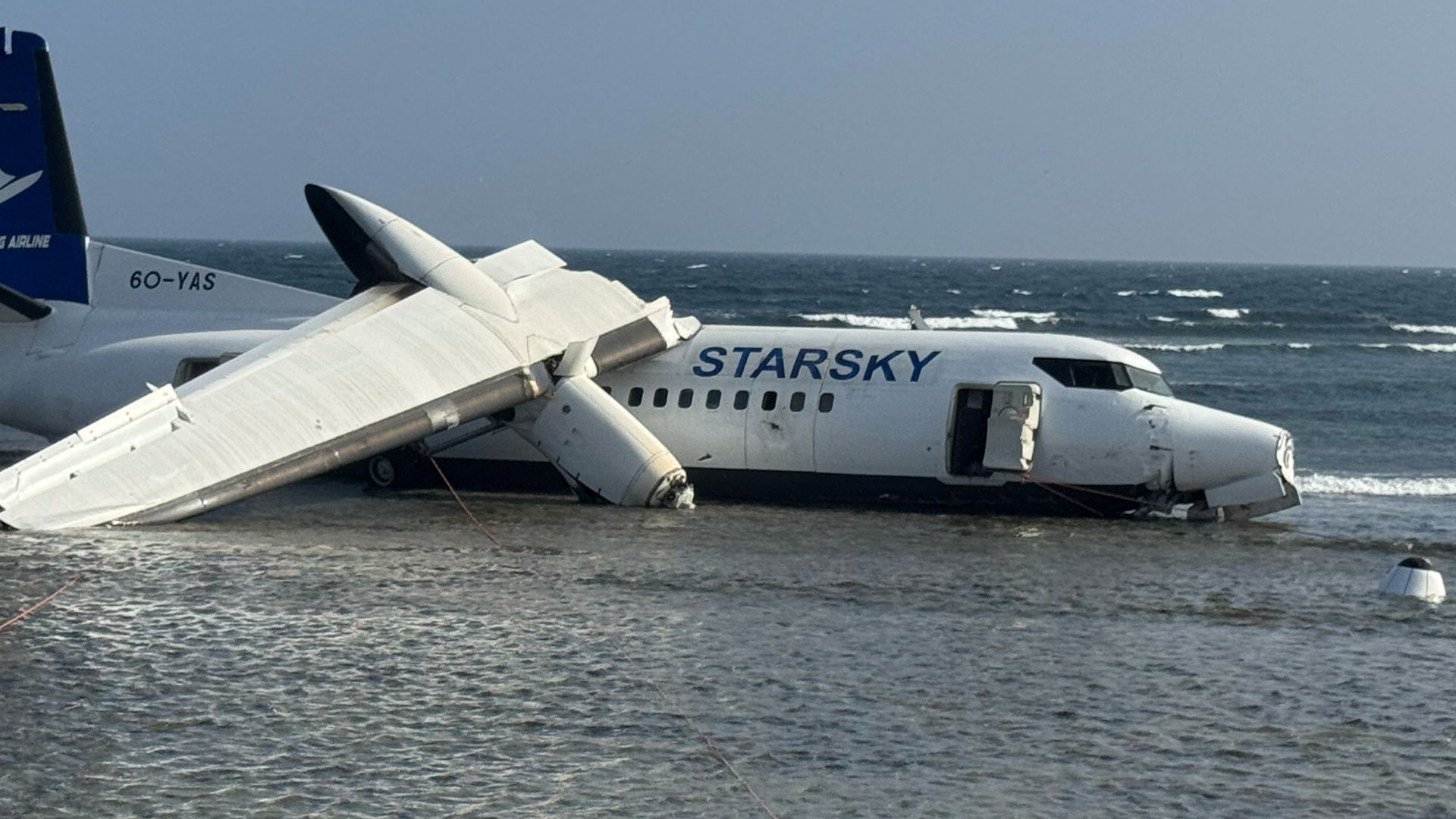 An aircraft carrying up to 50 people on the shoreline after veering off the runway during an emergency crash-landing at Somalia's main airport in Mogadishu, Somalia.