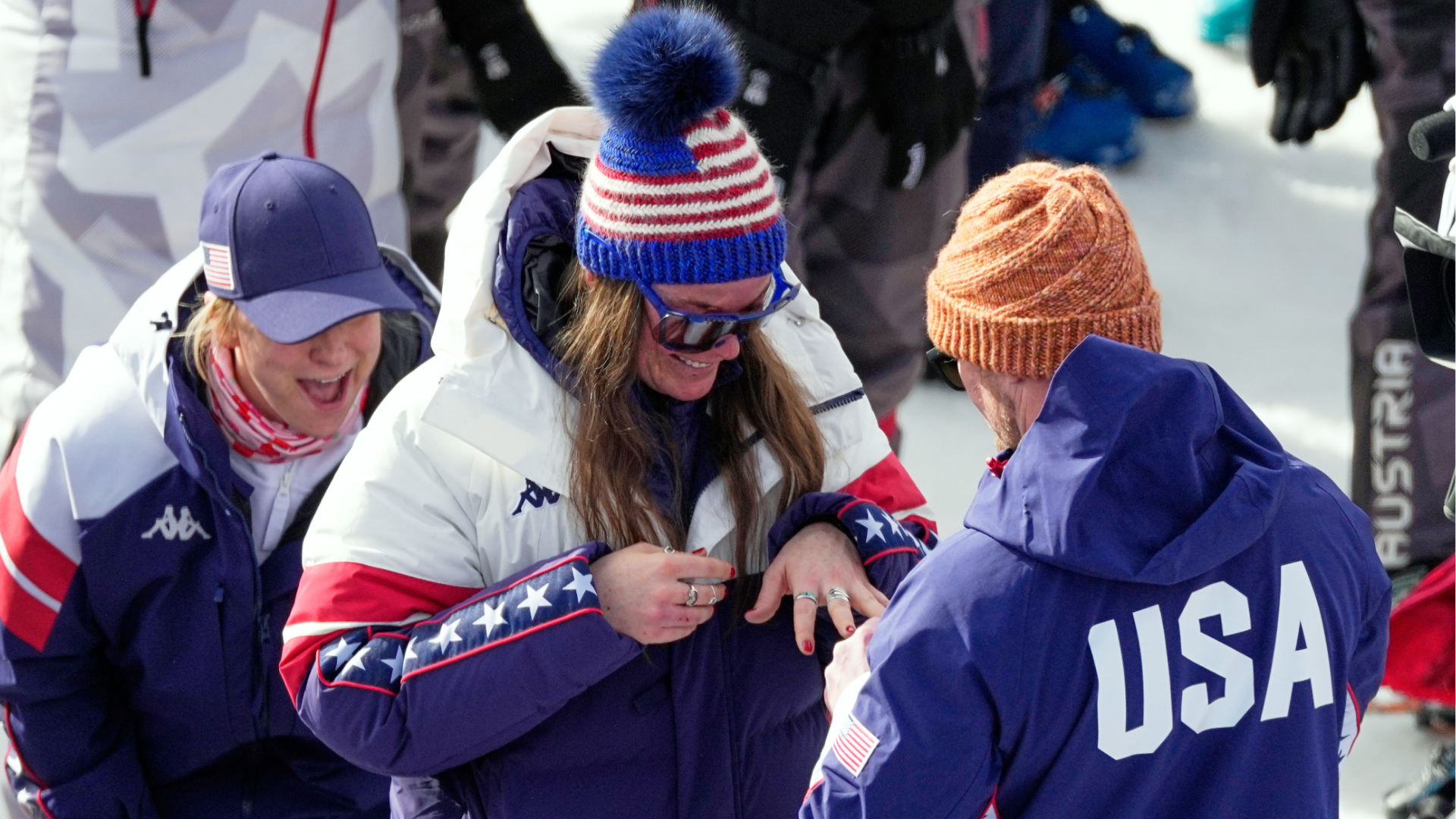 United States' Breezy Johnson looks at the engagement ring she was given by Connor Watkins, at the finish area of an alpine ski, women's super-G race, at the 2026 Winter Olympics, in Cortina d'Ampezzo, Italy, Thursday, Feb. 12, 2026.