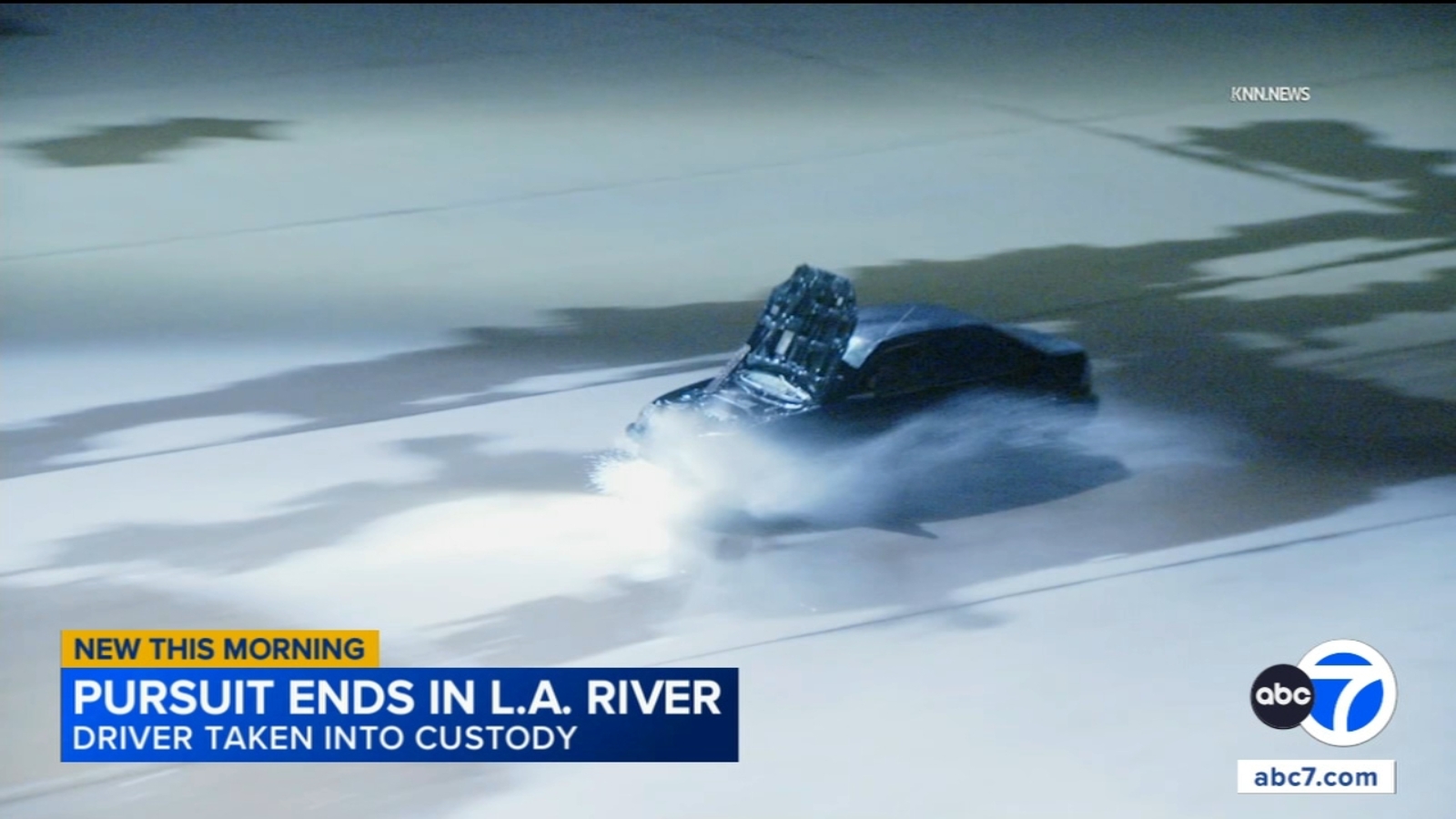 Suspect drives through LA River with hood blocking windshield during chase