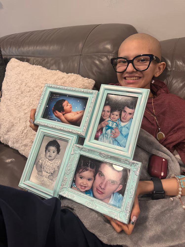 Cancer patient Ofelia Torres holds up her baby photos, some of the include her father Ruben Torres-Maldonado. He will be released from immigration detention as early as Thursday.