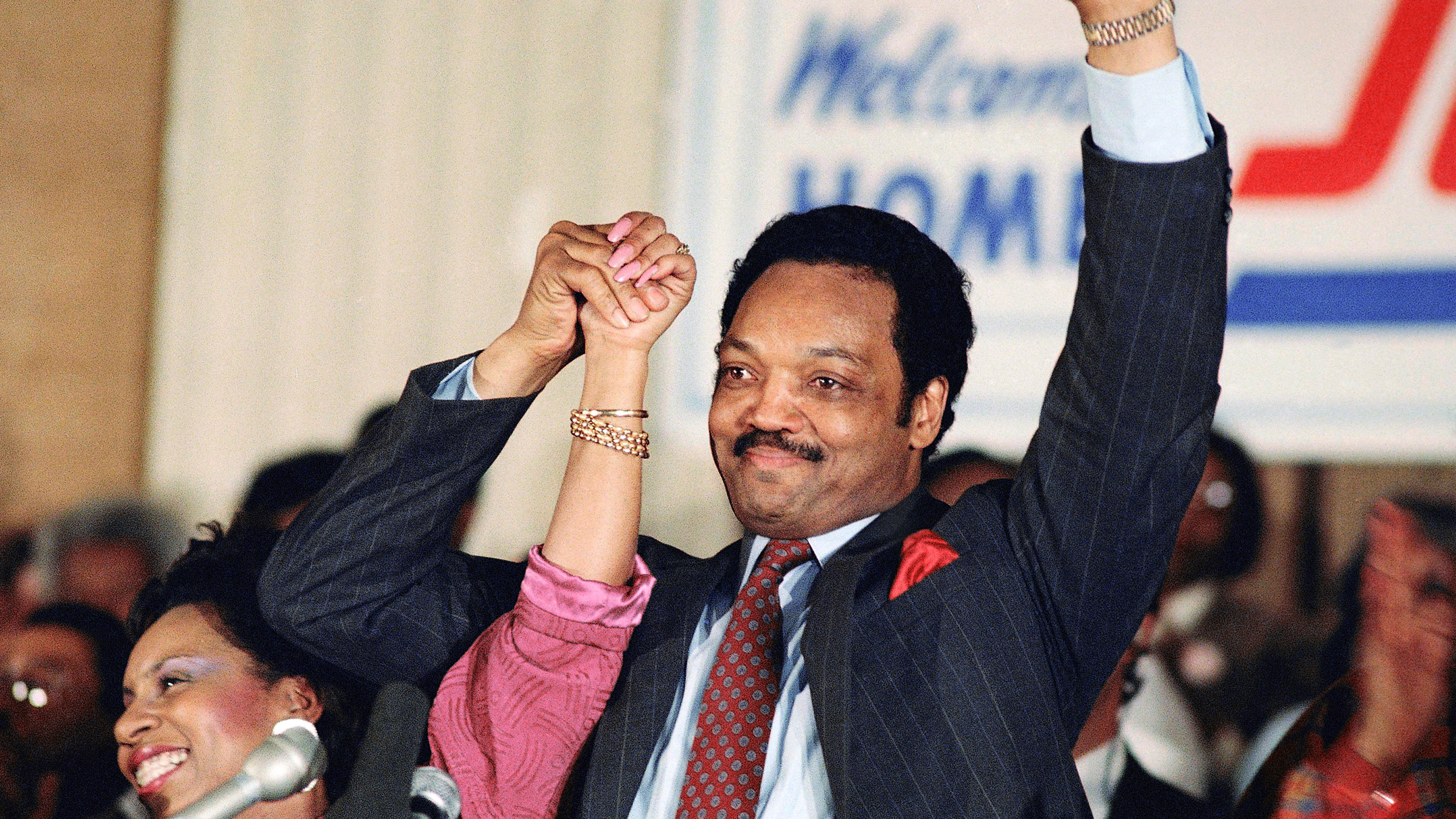 Democratic presidential hopeful Jesse Jackson with his wife, Jacqueline, salutes the cheering crowd at Operation Push in Chicago, March 10, 1988.
