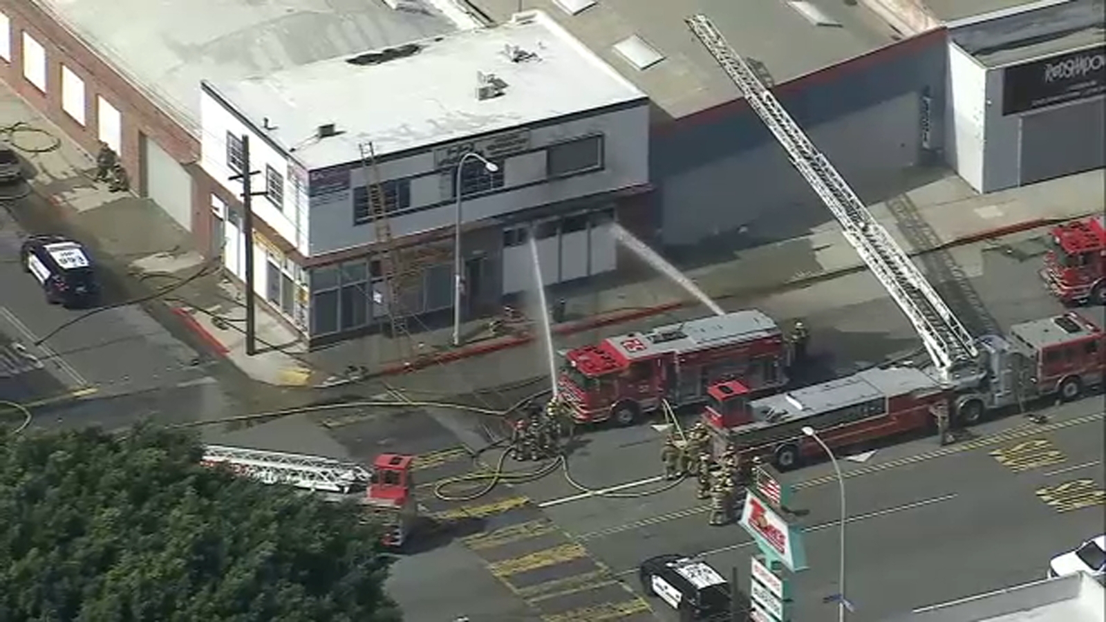 SWAT team, suspects in standoff after fire erupts at auto parts store in Huntington Park