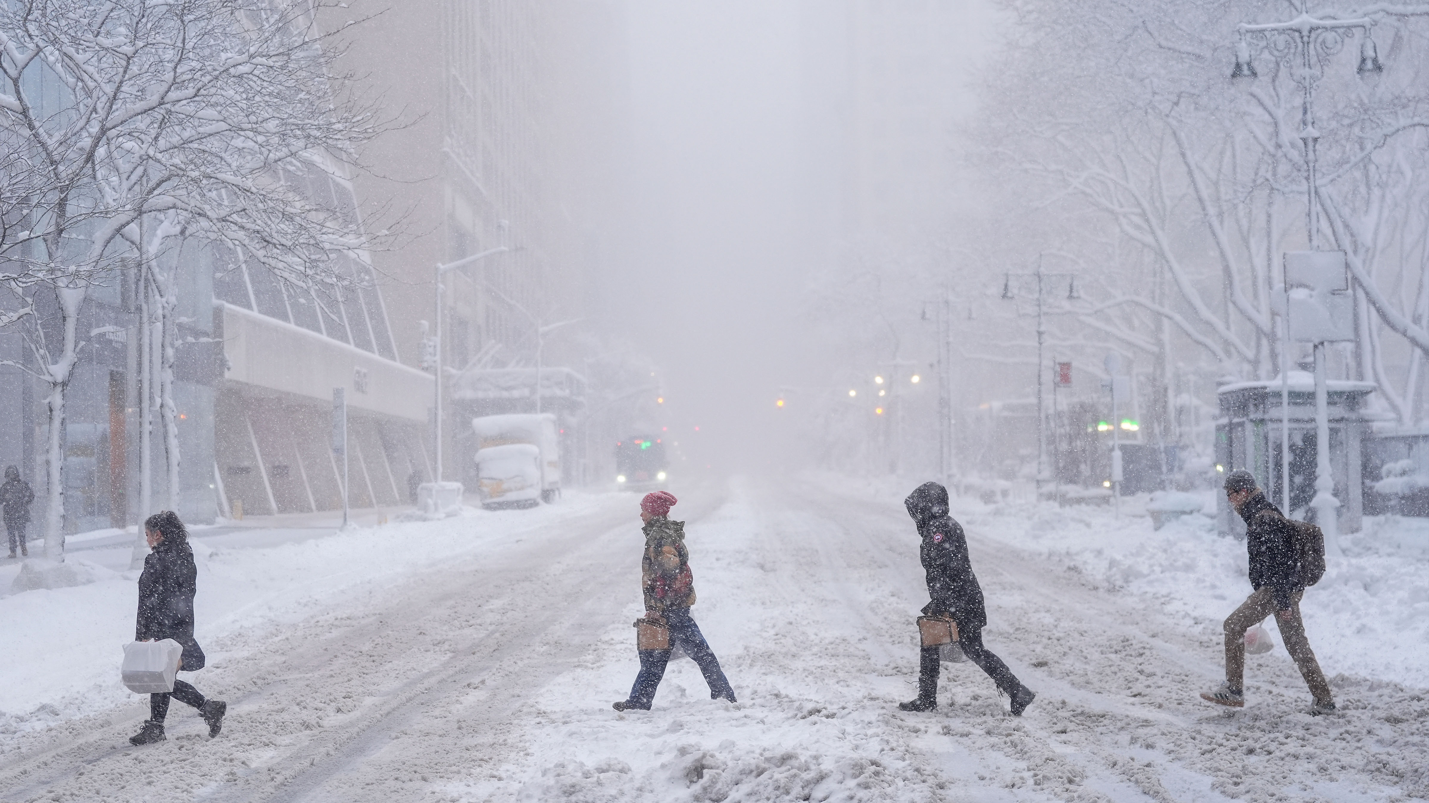 Pedestrians cross 42nd Street near Bryant Park during a snow storm, Monday, Feb. 23, 2026, in New York. 
