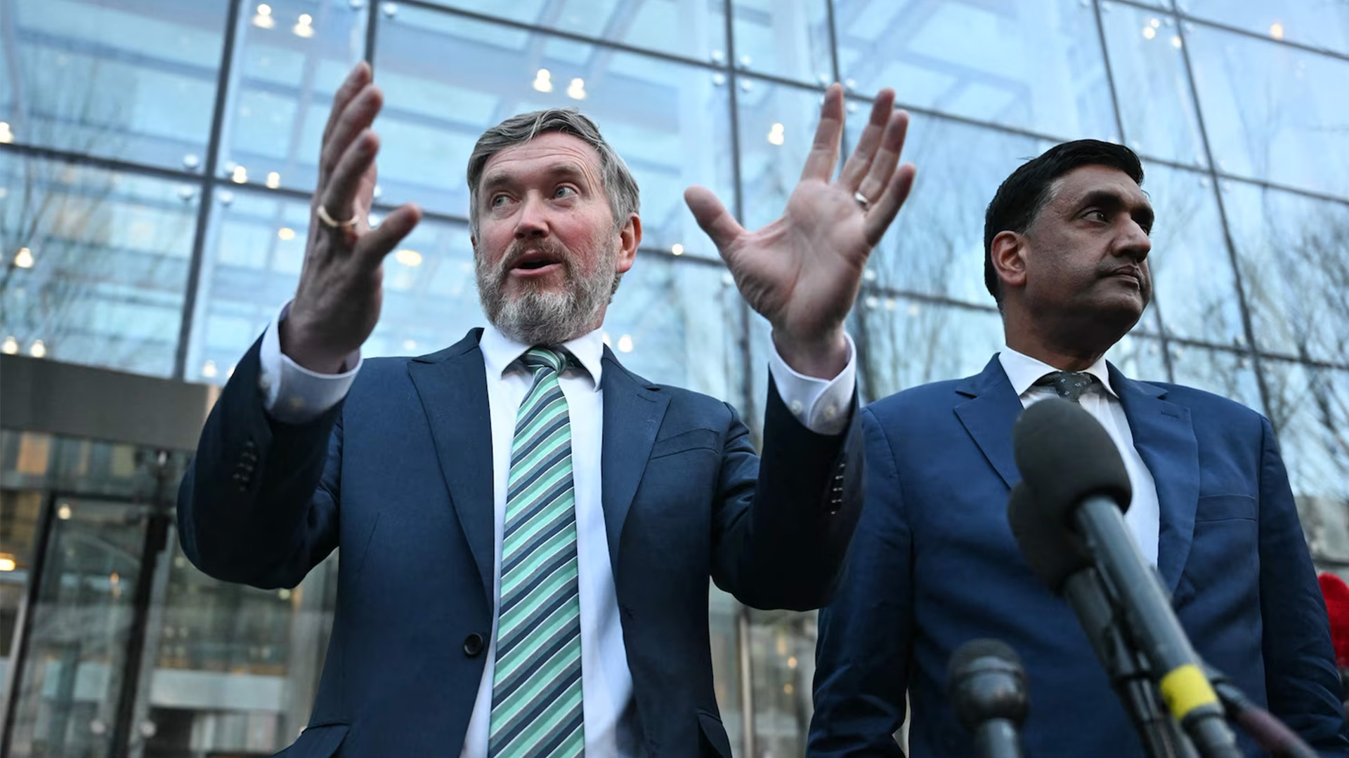 Representatives Thomas Massie and Ro Khanna speak outside the Department of Justice in Washington, February 9, 2026.