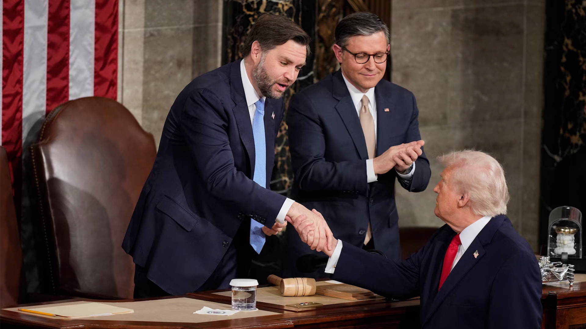 Vice President JD Vance and Speaker Mike Johnson shake hands with President Donald Trump following his State of the Union address at the U.S. Capitol in Washington, Feb. 24, 2026.