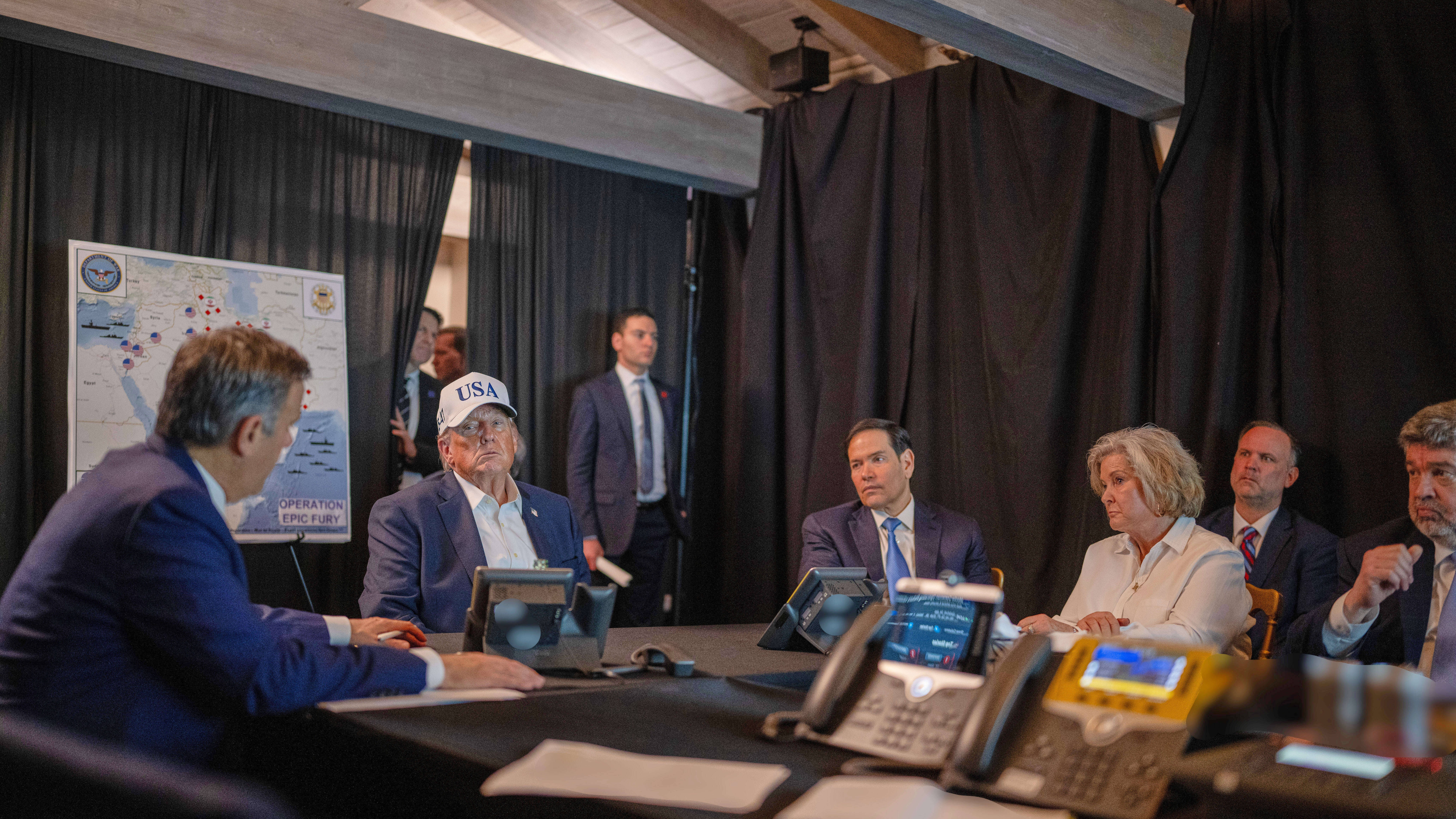 President Donald Trump talking with CIA Director John Ratcliffe, left, Secretary of State Marco Rubio, and White House chief of staff Susie Wiles at Mar-a-Lago.