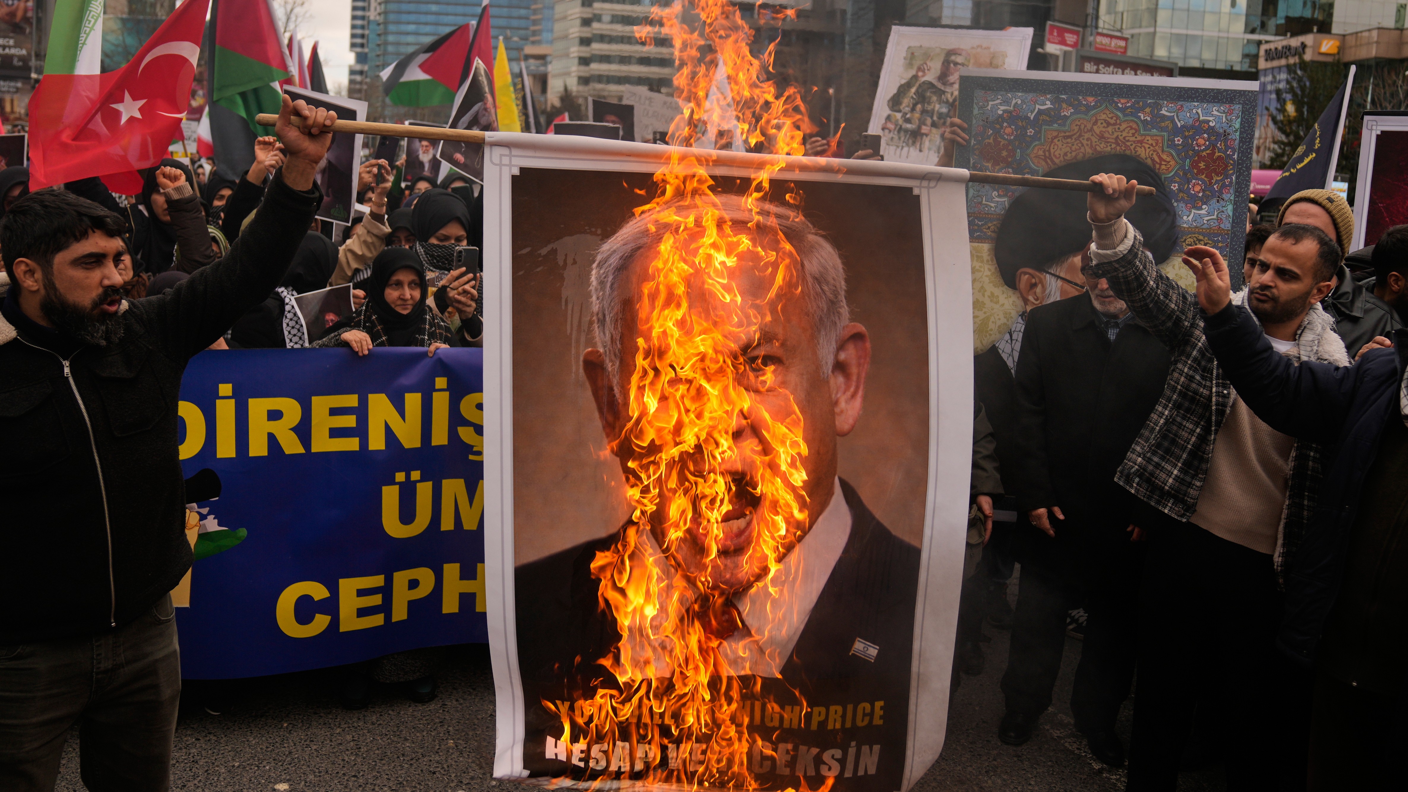 Demonstrators burn a picture of Israeli Prime Minister Benjamin Netanyahu during a protest outside the Israeli consulate in Istanbul, Sunday, March 1, 2026.