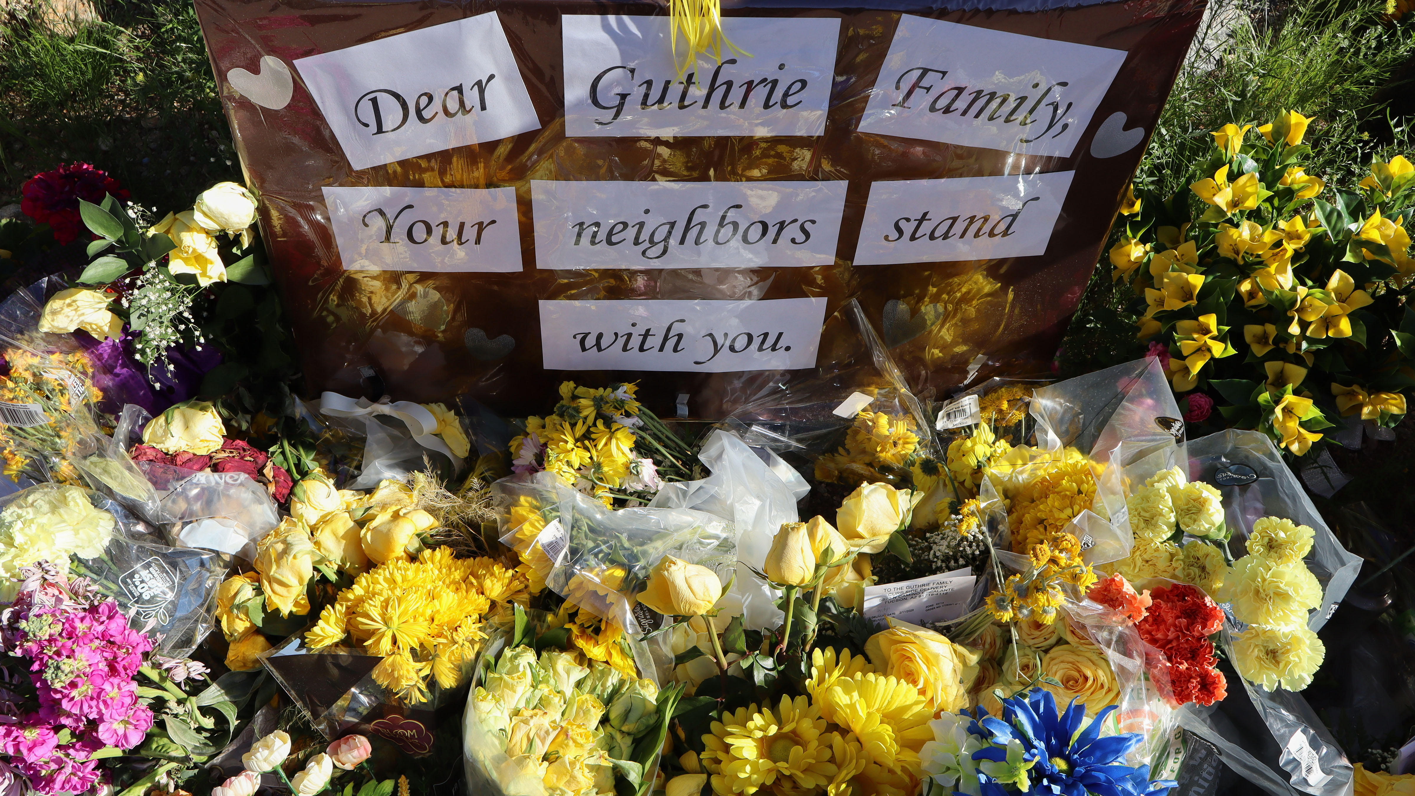 A memorial grows outside the home of Nancy Guthrie, the missing mother of "Today" show host Savannah Guthrie, Sunday, Feb. 22, 2026, in Tucson, Ariz. 