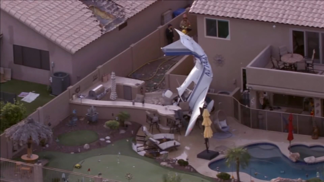 Small plane hits homes in Phoenix, crashes nose-down next to backyard pool, injuring 3