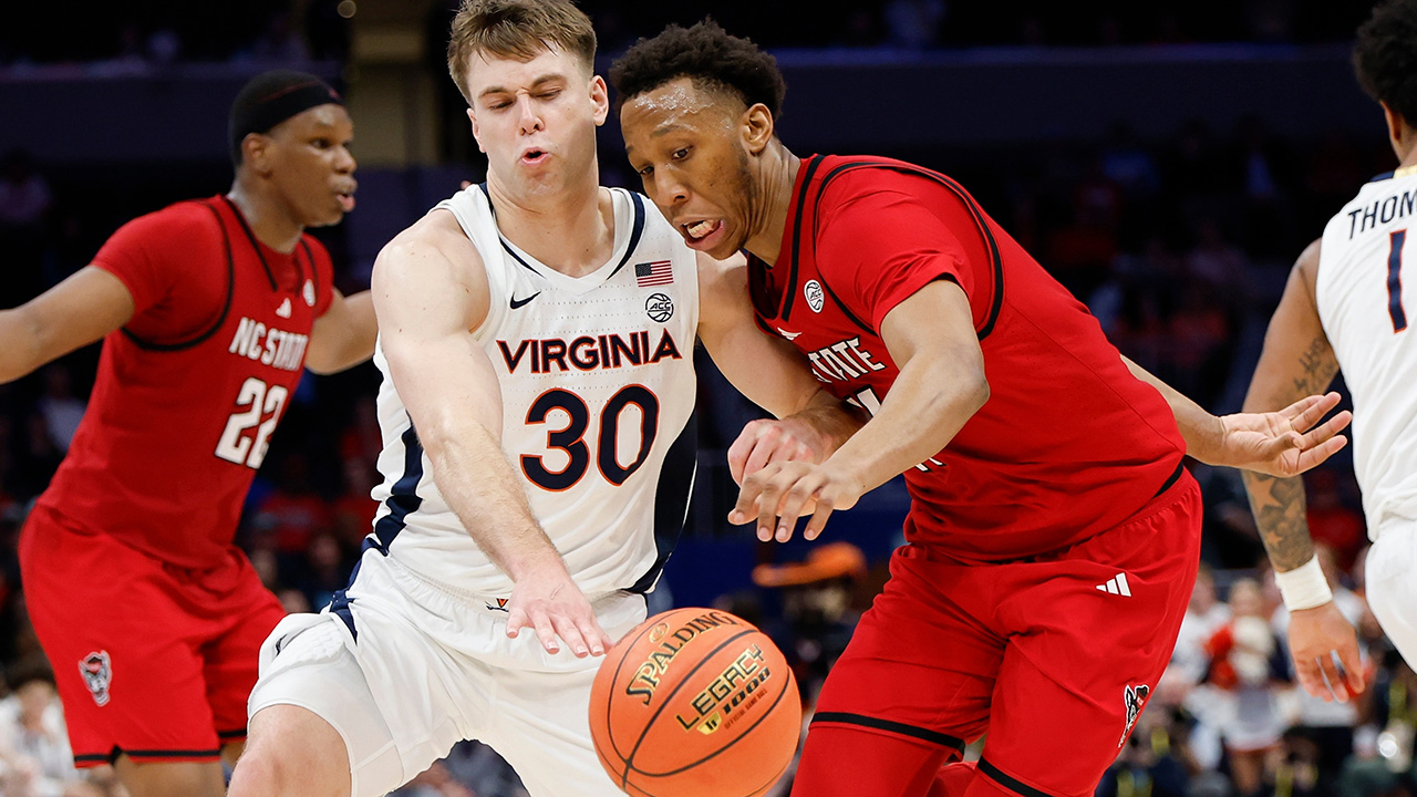 N.C. State's Quadir Copeland and Virginia guard Dallin Hall battle for a loose ball during the ACC Tournament on Thursday in Charlotte.