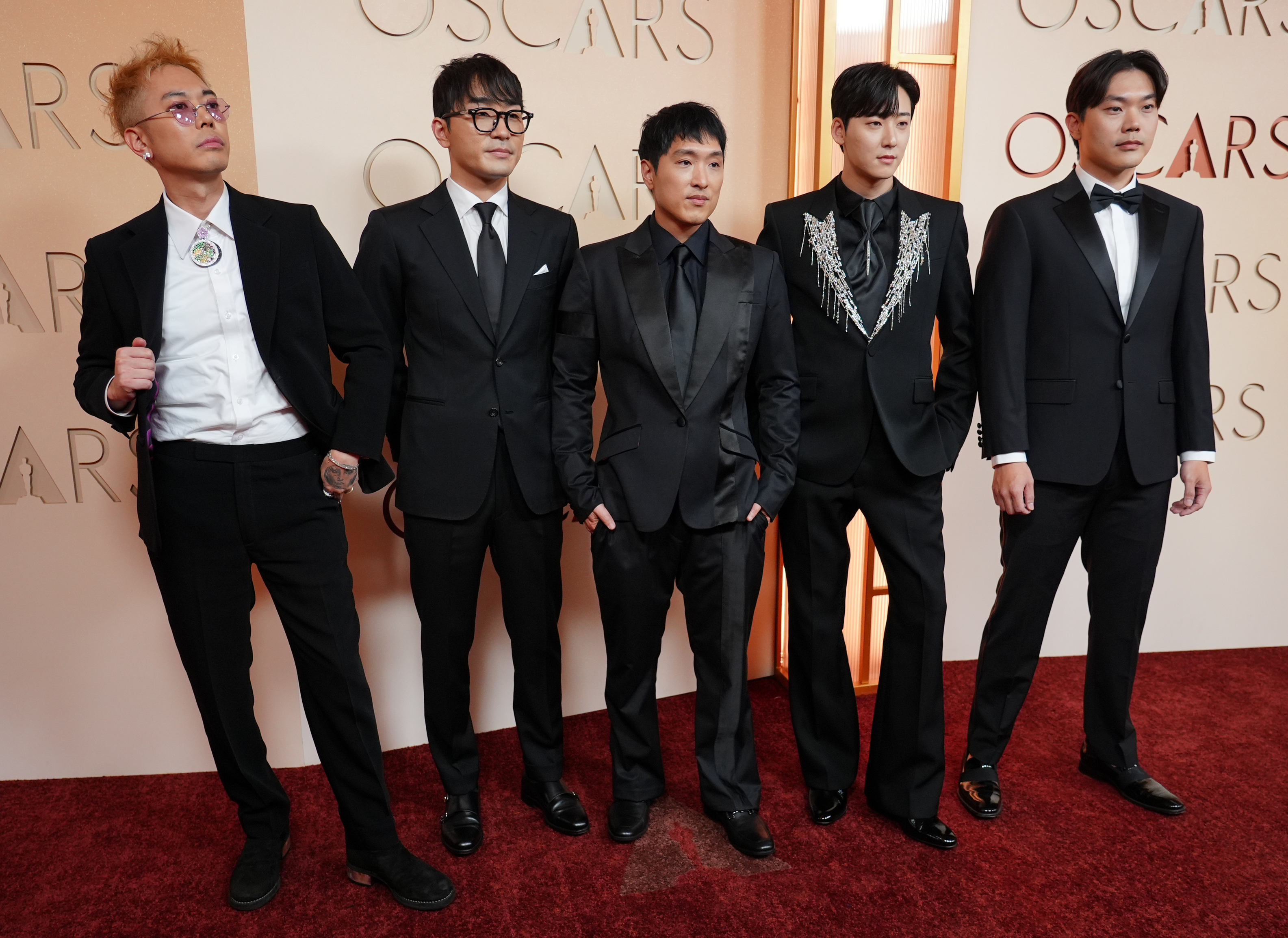 Danny Chung, from left, Andrew Choi, Neckwav, Kevin Woo, and SamUIL Lee arrive at the Oscars on Sunday, March 15, 2026, at the Dolby Theatre in Los Angeles.