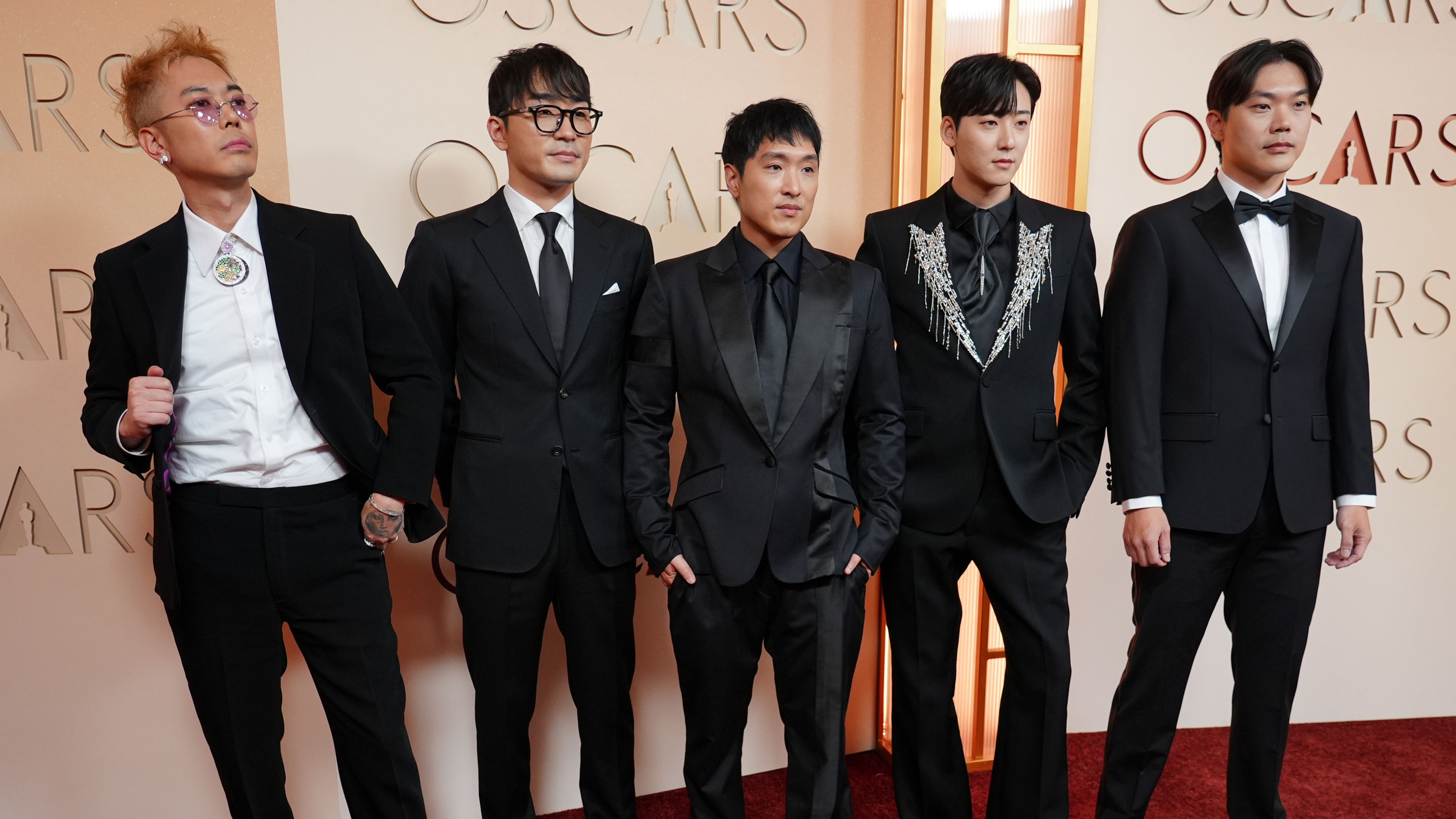 Danny Chung, from left, Andrew Choi, Neckwav, Kevin Woo, and SamUIL Lee arrive at the Oscars on Sunday, March 15, 2026, at the Dolby Theatre in Los Angeles.