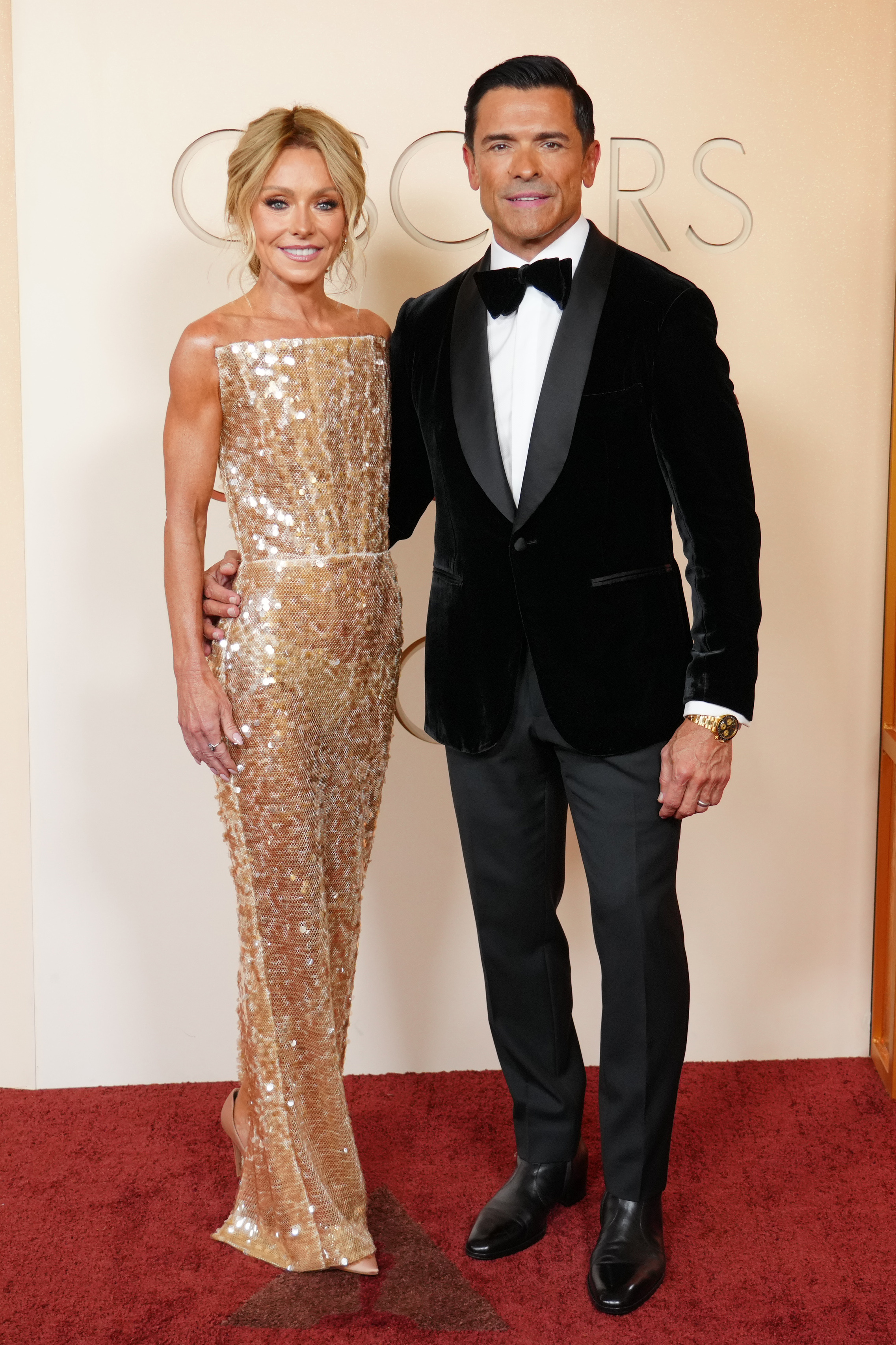 Kelly Ripa, left, and Mark Consuelos arrive at the Oscars on Sunday, March 15, 2026, at the Dolby Theatre in Los Angeles.