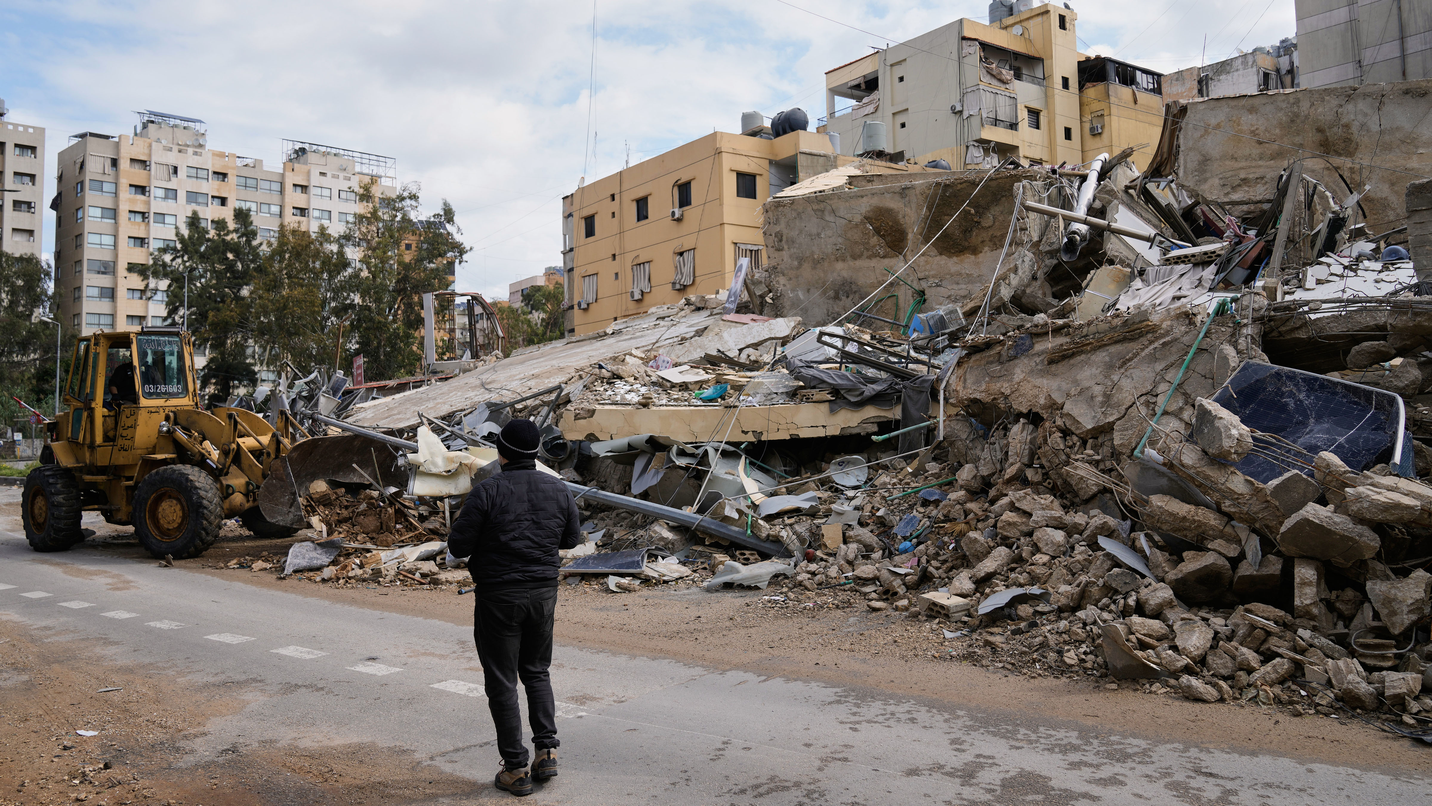 A bulldozer clears debris from the rubble of buildings destroyed in an Israeli airstrike, in Dahiyeh, Beirut's southern suburbs,, Lebanon, Monday, March 16, 2026.