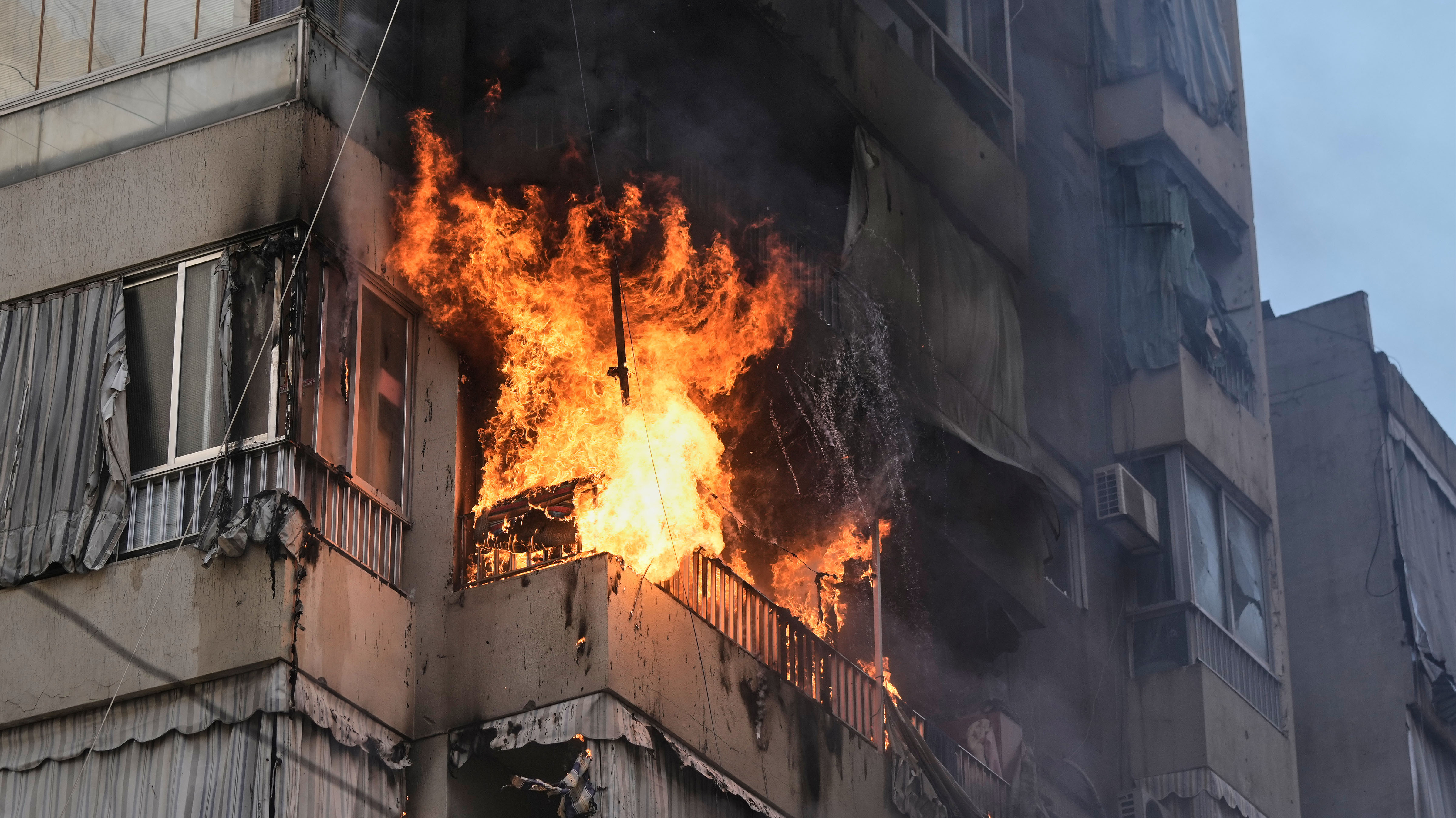 Smoke and flame rise from a residential building following an Israeli airstrike in central Beirut, Lebanon, Wednesday, March 18, 2026.