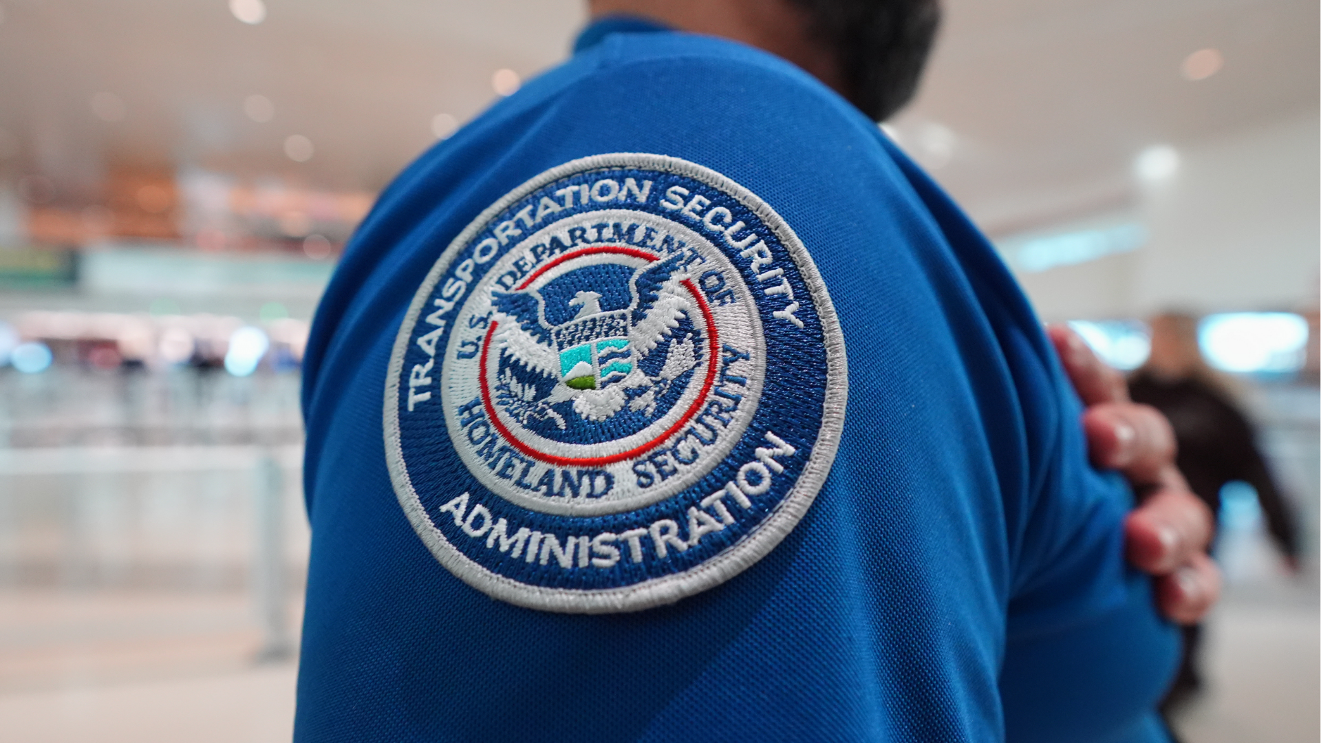 A TSA agent wears a U.S. Department of Homeland Security patch on their uniform at Love Field Airport, in Dallas, Wednesday, Feb. 18, 2026.