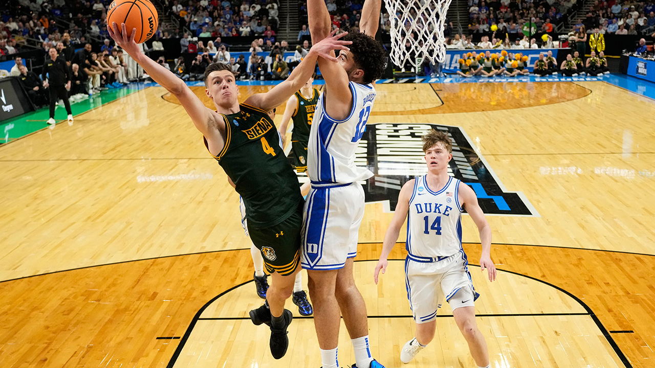 Siena guard Gavin Doty drives to the basket past Duke forward Cameron Boozer at the NCAA tournament on Thursday in Greenville, S.C.