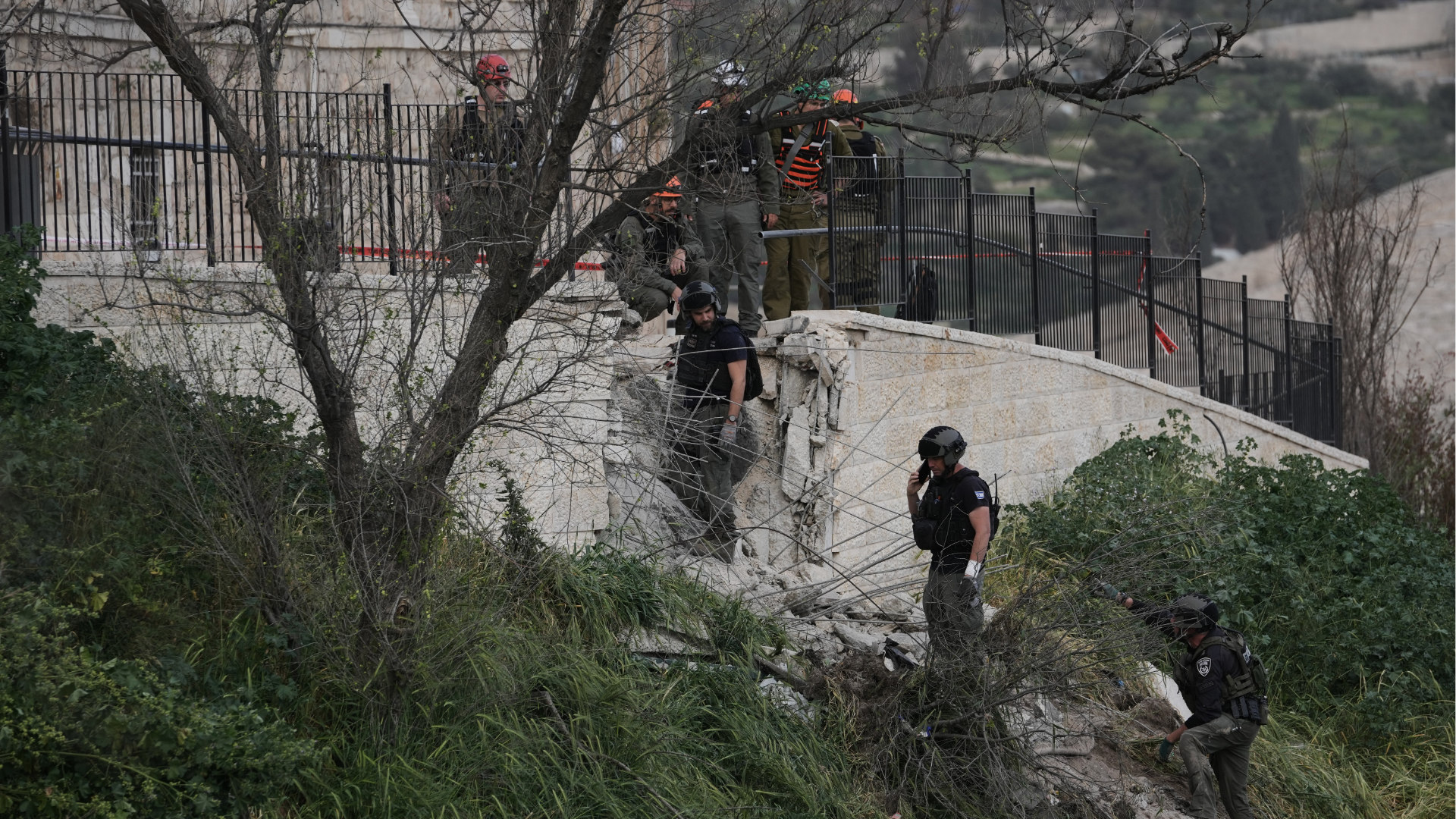 Israeli police officers inspect the damage at the site of an Iranian missile strike in Jerusalem's Old City Friday, March 20, 2026.