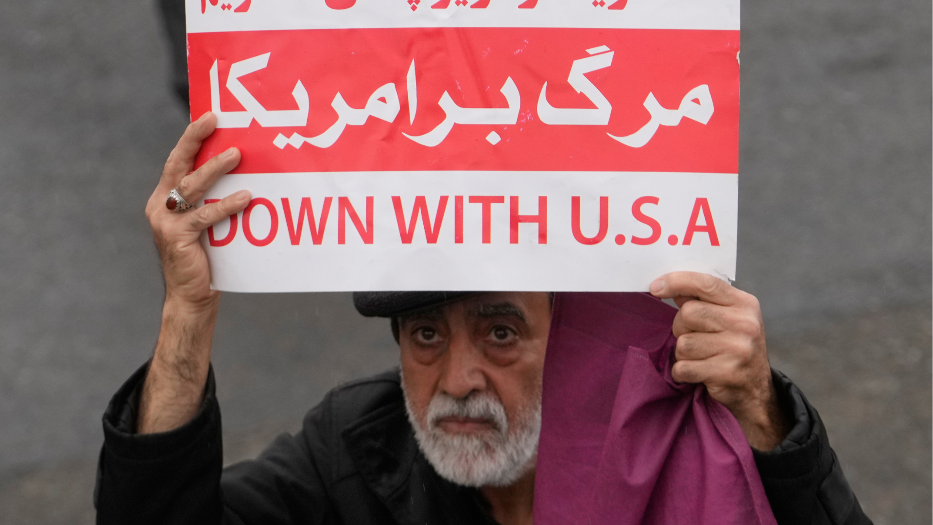 A man holds a poster as he leaves after the conclusion of the Friday prayers at the Imam Khomeini Grand Mosque in Tehran, Iran, Friday, March 20, 2026.
