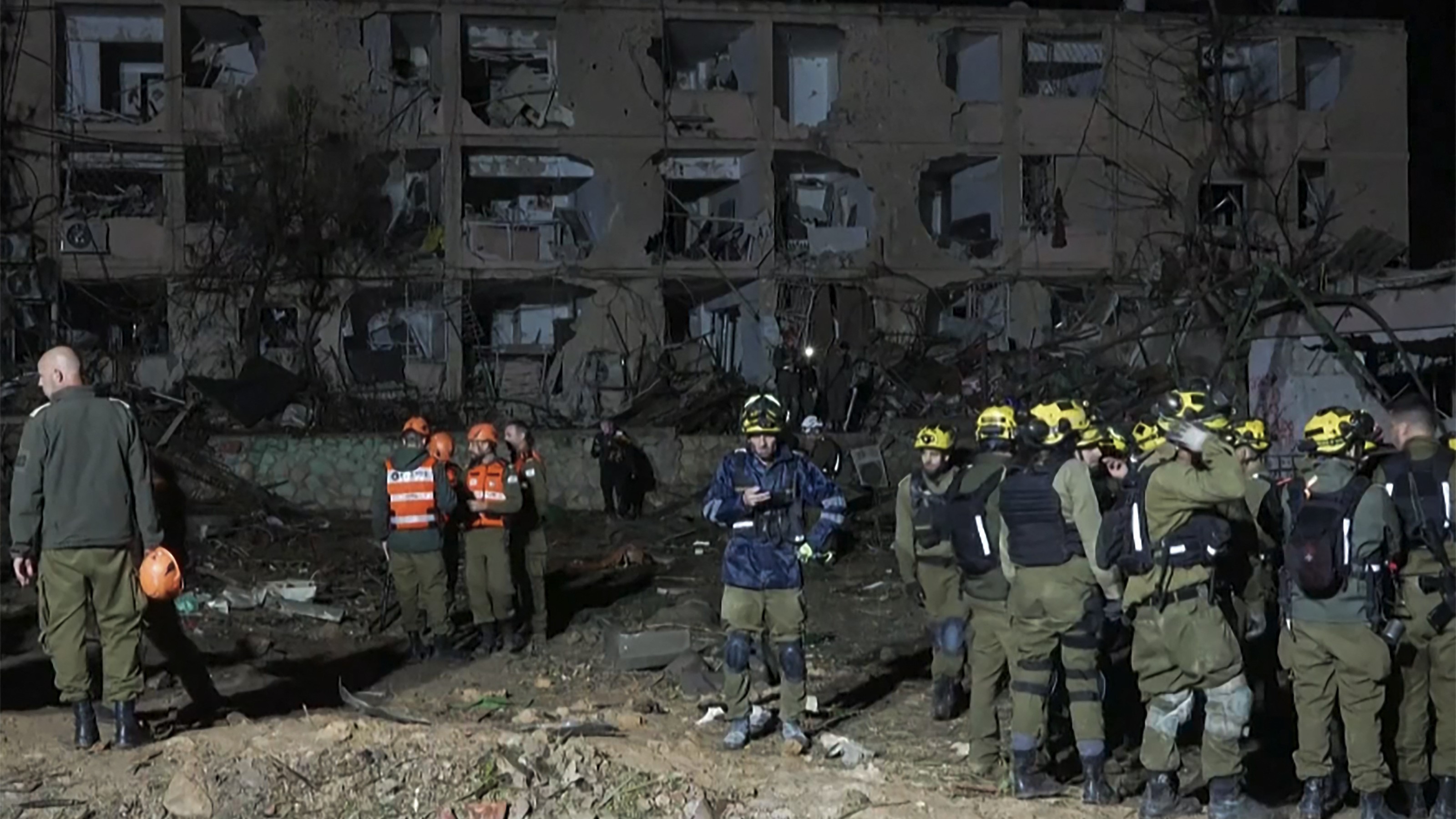 This frame grab from AFPTV footage shows first responders inspecting the site of an Iranian missile strike in Dimona on March 21, 2026.