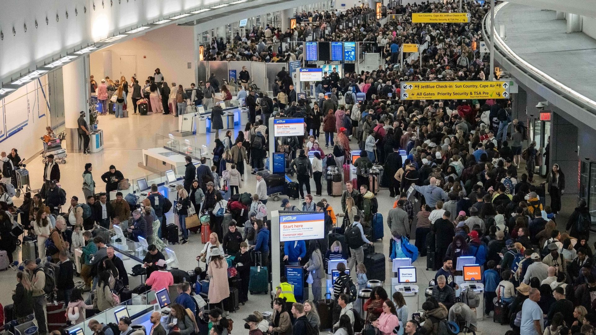 People wait in a TSA line at the John F. Kennedy International Airport, Sunday, March 22, 2026, in New York.