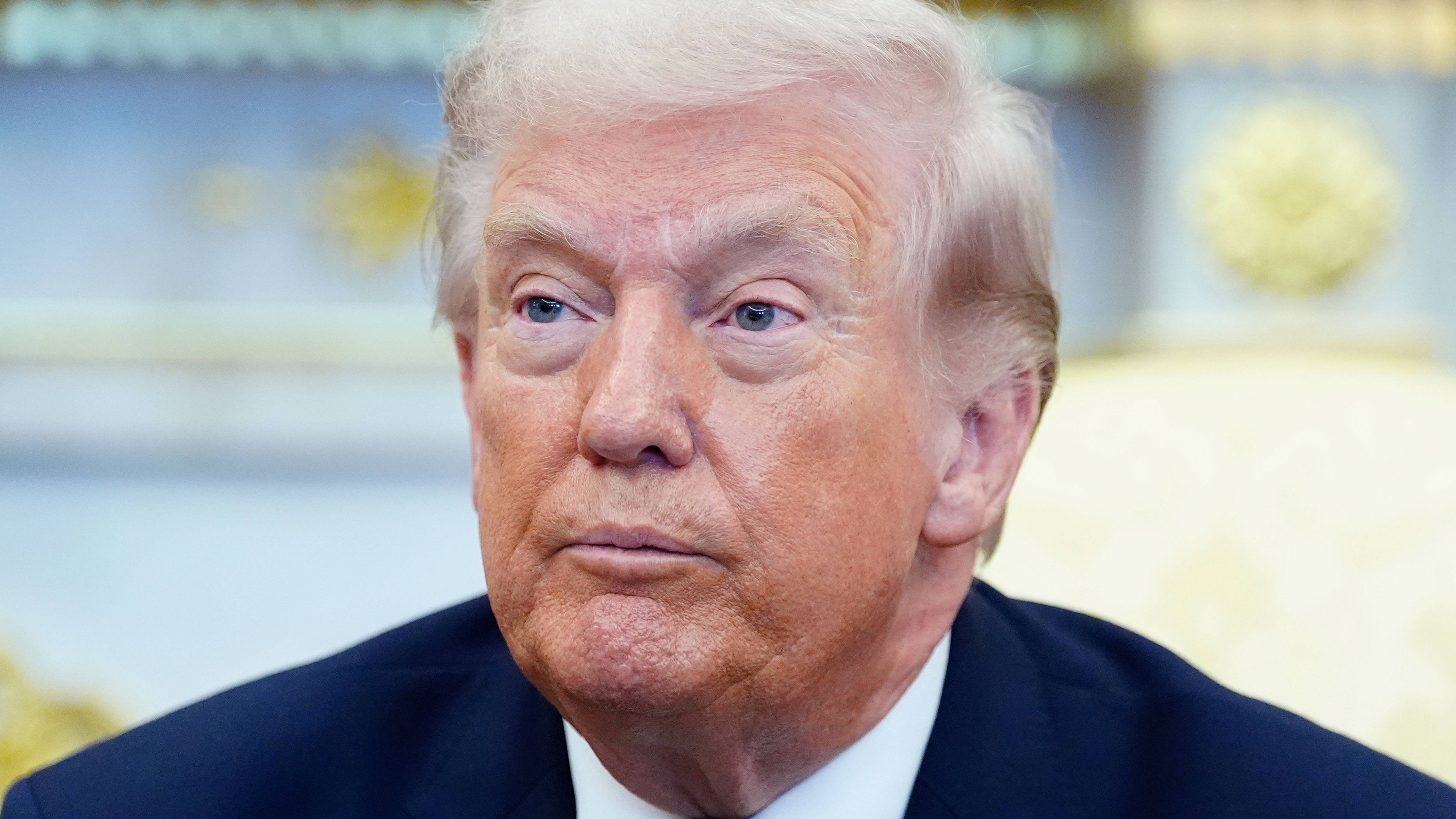 President Donald Trump listens to a reporter's question during a meeting with Irish Prime Minister Micheál Martin in the Oval Office of the White House, on St. Patrick's Day.