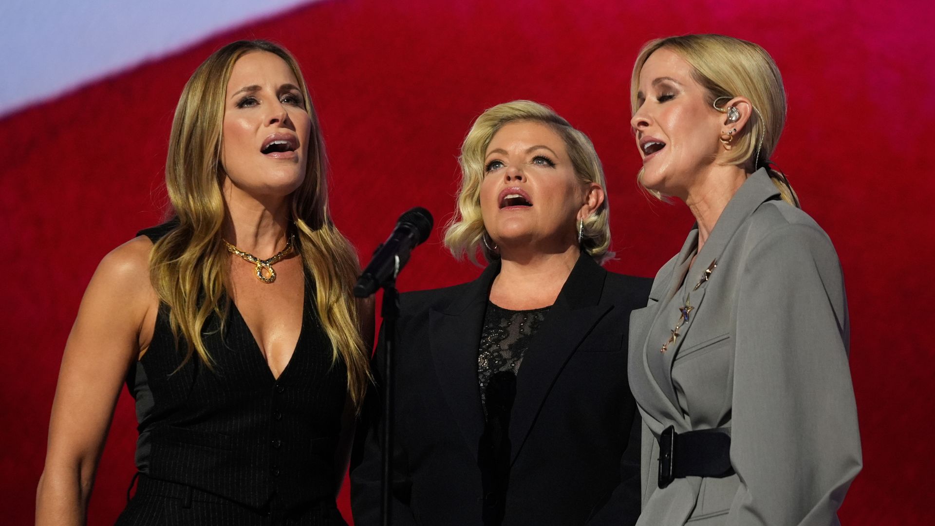 Emily Robison, from left, Natalie Maines and Martie Maguire, of The Chicks, sing the national anthem during the Democratic National Convention Thursday, Aug. 22, 2024, in Chicago.