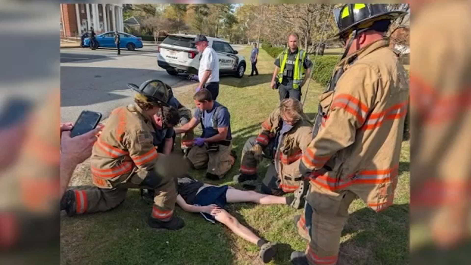 First responders tend to Axel Henderson after he was hit by a Fuqua-Varina police cruiser on Monday.