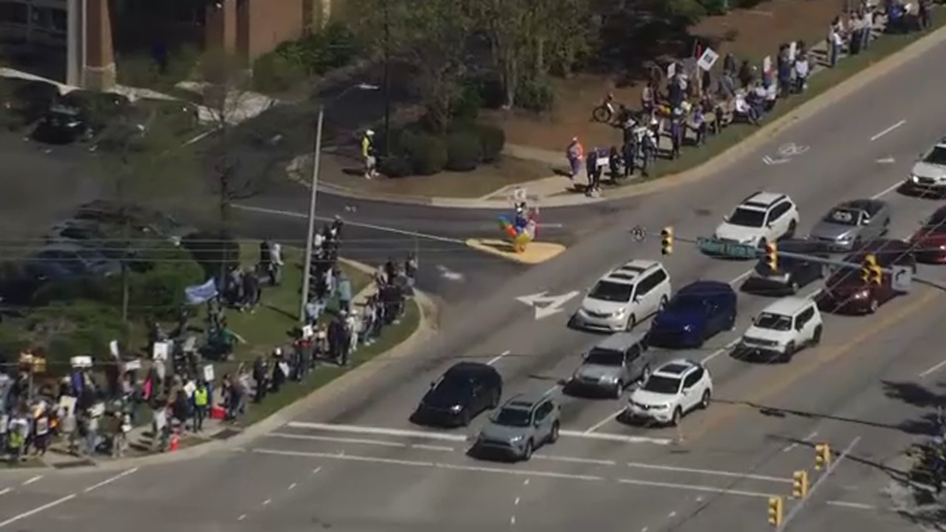 "No Kings" protesters demonstrate in Cary on Saturday.