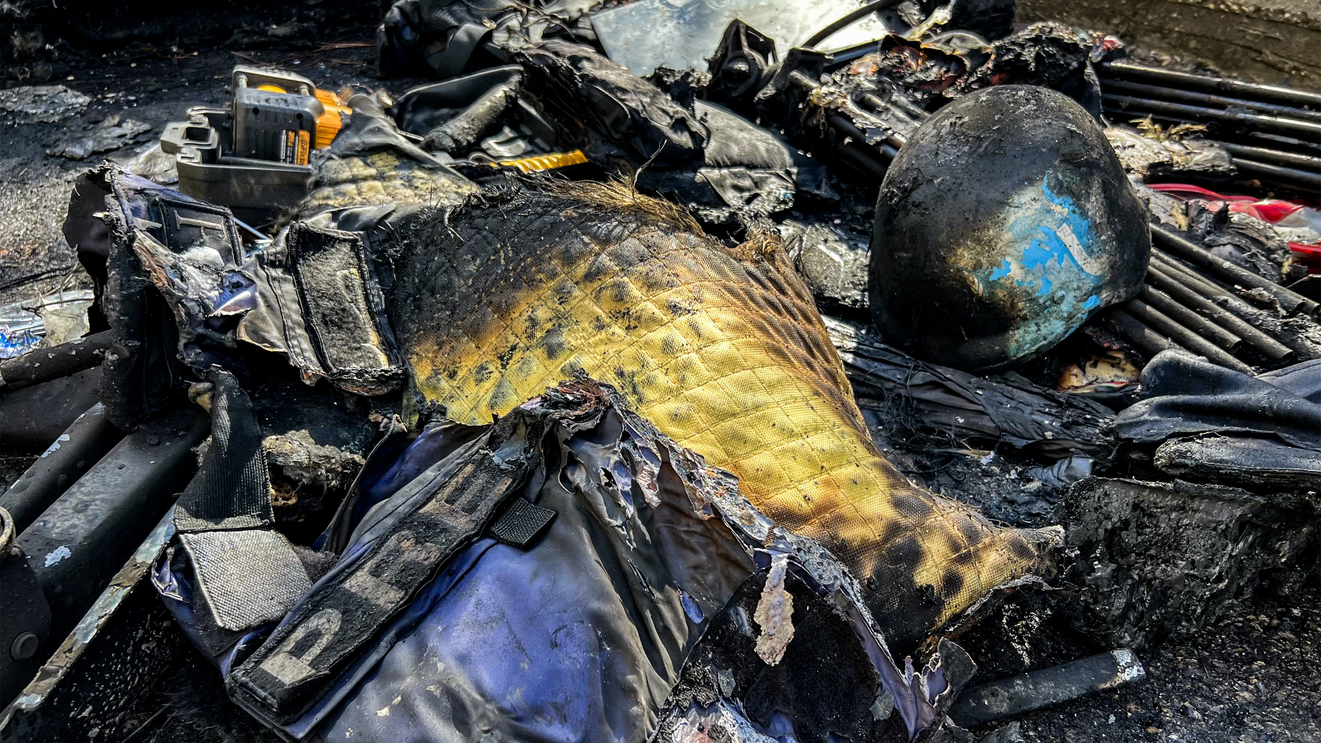 Gear that was used by a media crew of journalists who were killed in an Isareli strike earlier is displayed near the husk of their destroyed vehicle in Lebanon on March 28, 2026.