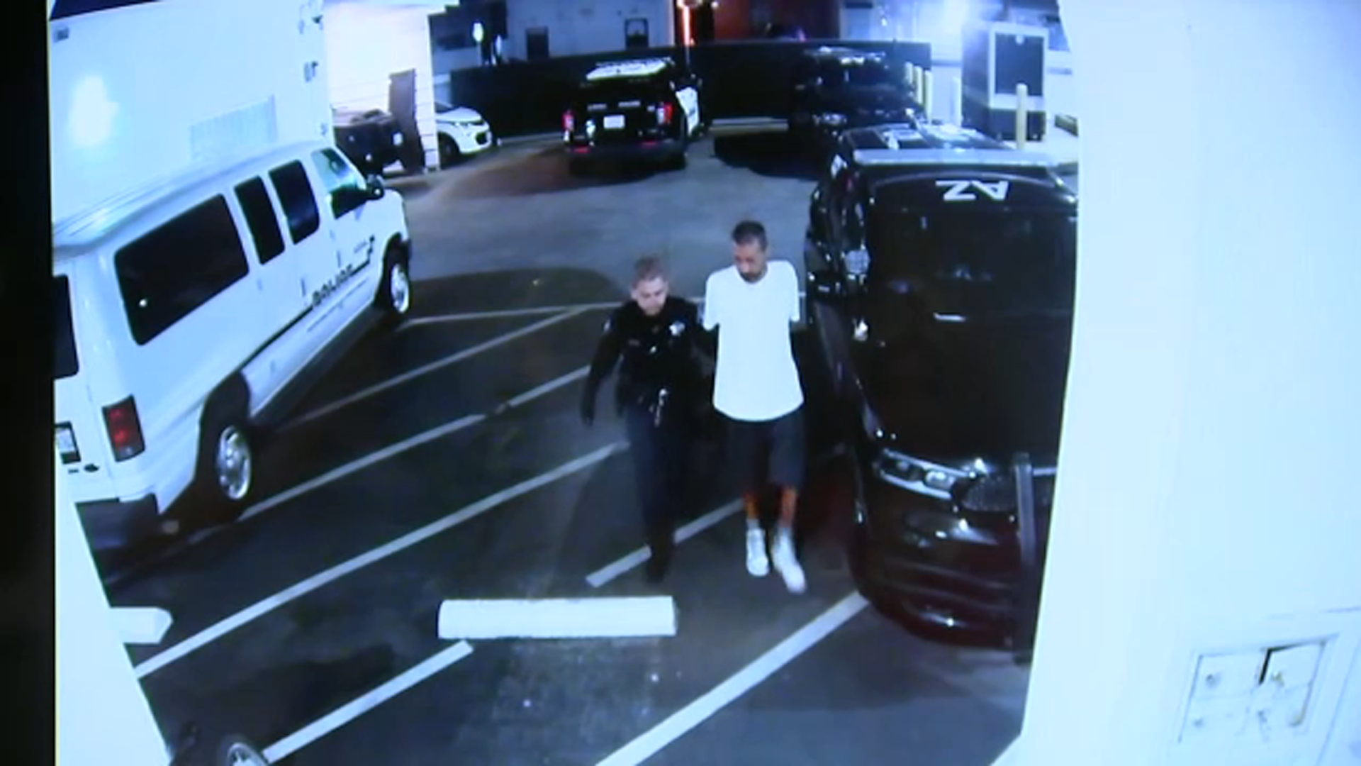 A still from surveillance video released by the Azusa Police Department shows Eric Valencia being escorted into the Azusa Police Station on Friday, March 20.