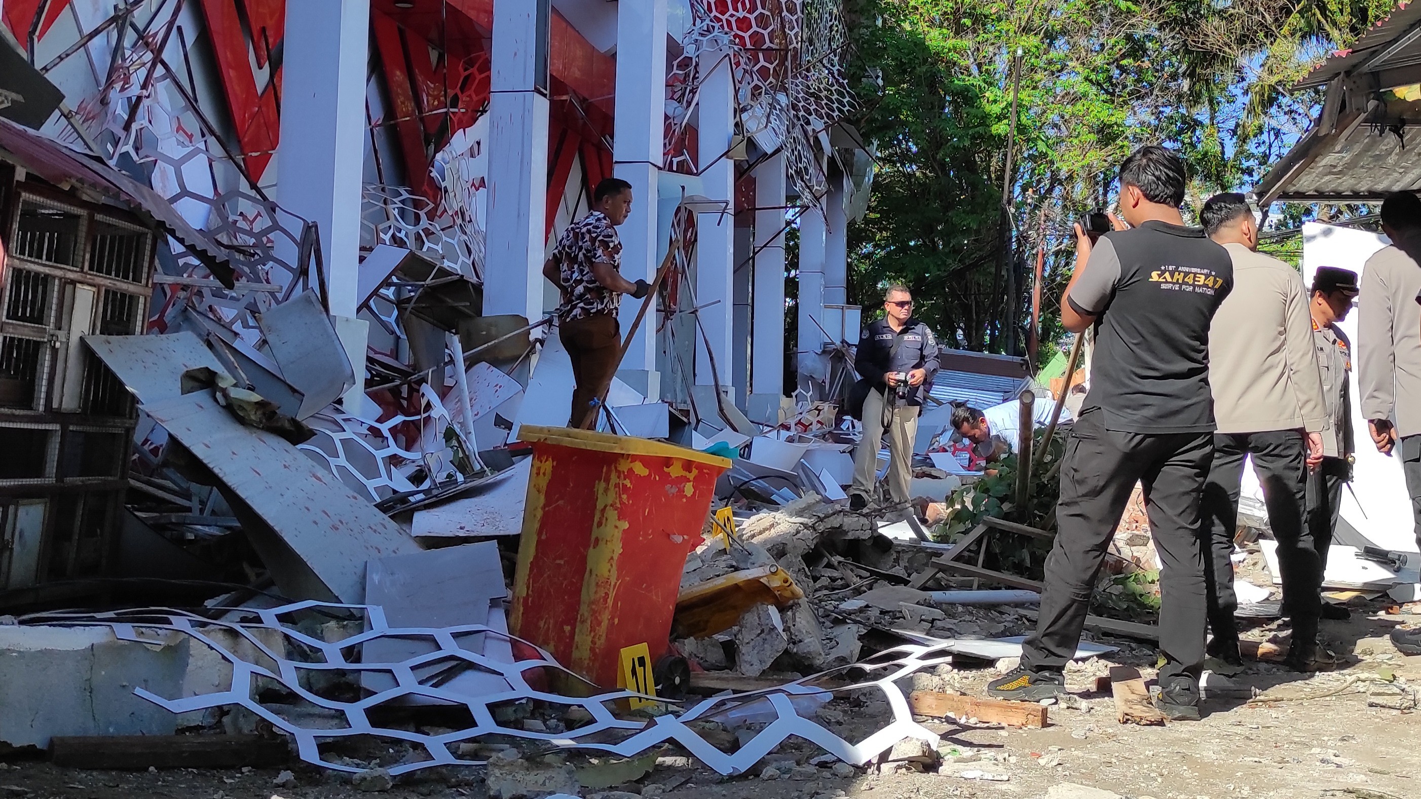 Police officers inspect a damaged building following an earthquake in Manado, North Sulawesi, Indonesia, Thursday, April 2, 2026.
